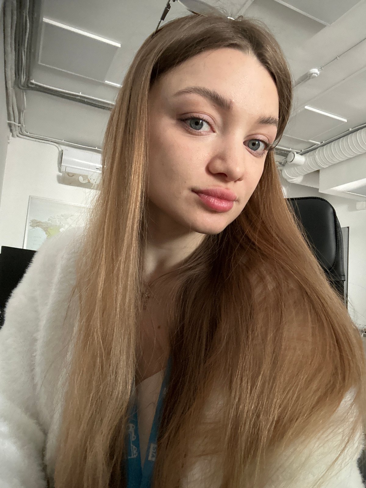 Young woman photographed indoors with flowing light brown hair