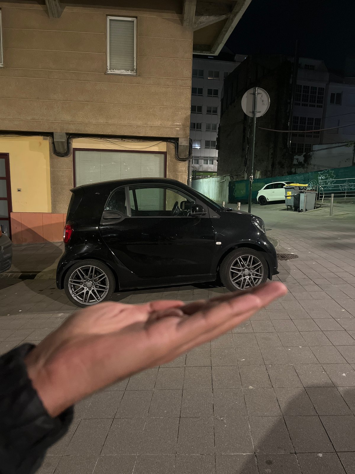 Smart car parked on cobblestone street in A Coruña