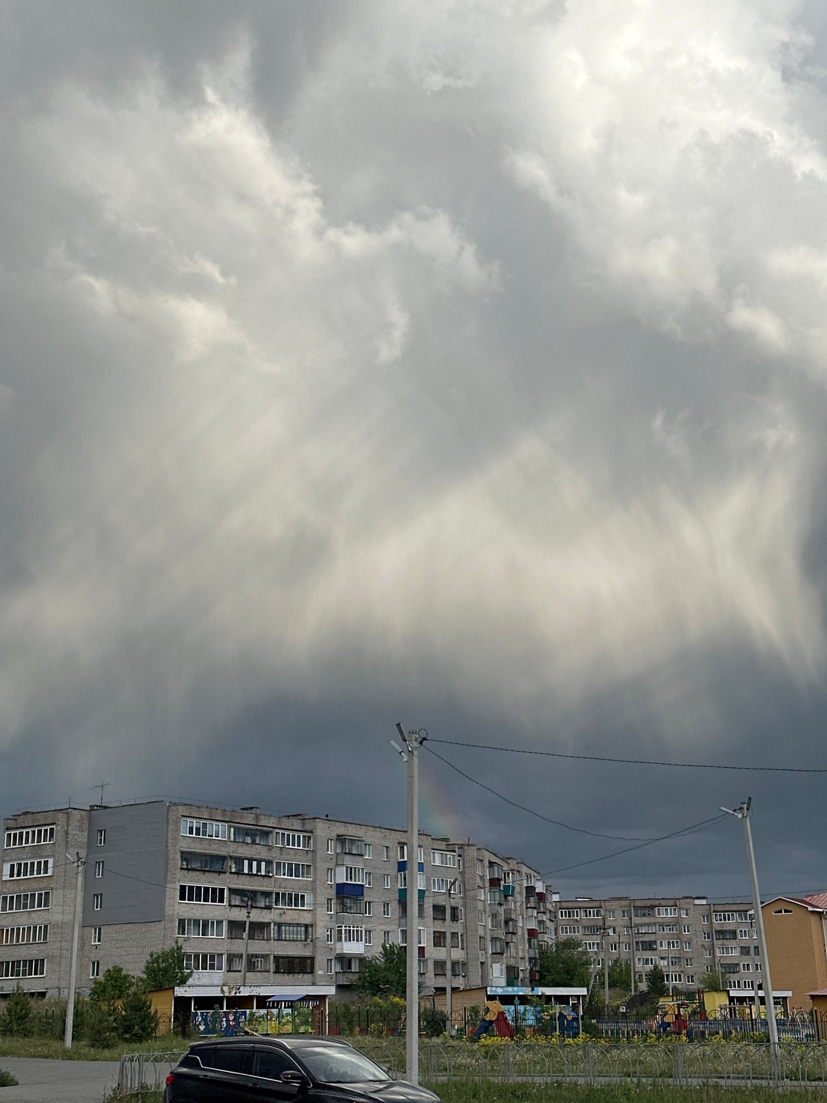 Overcast day captures Soviet-era apartments with playground area