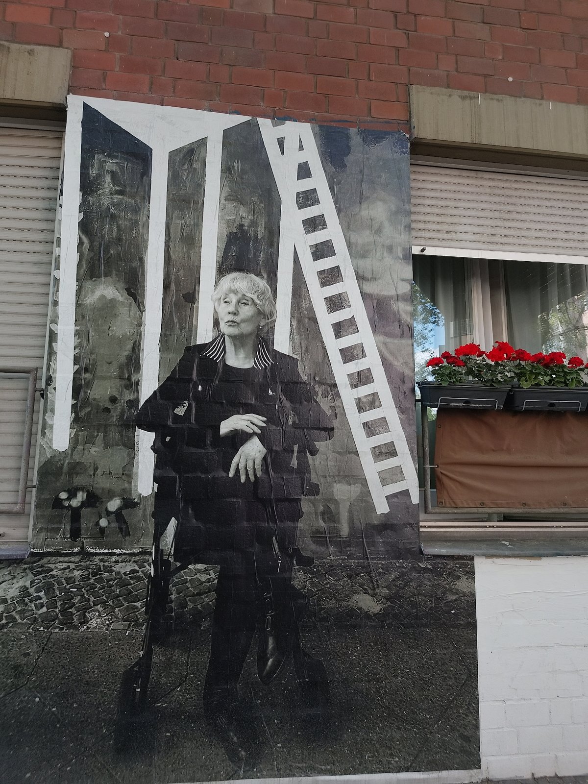 Museum visitors document German history exhibits and street murals