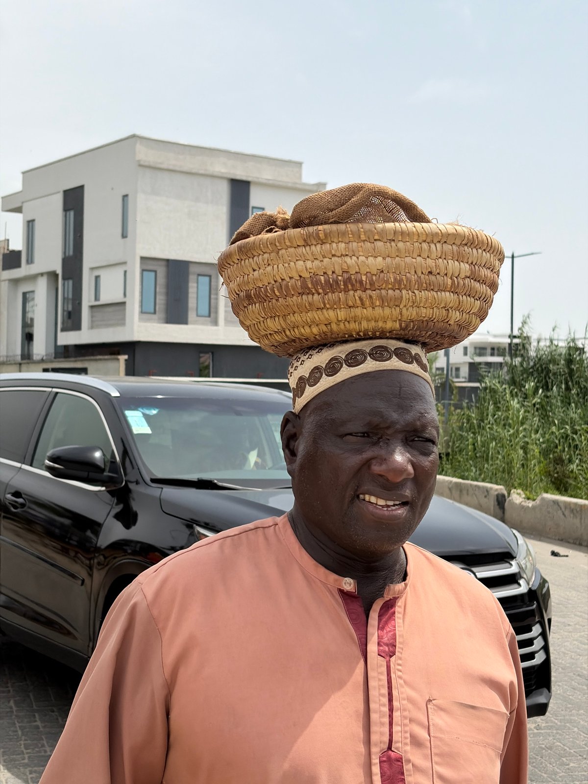 Man in traditional dress spotted near Mercedes in Moba