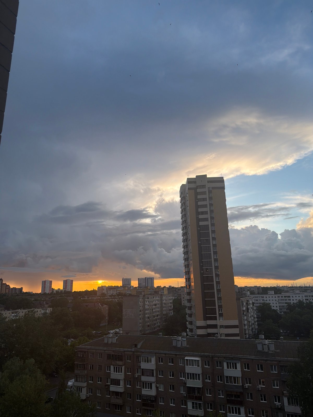 Urban sunset documented from elevated viewpoint over residential cityscape