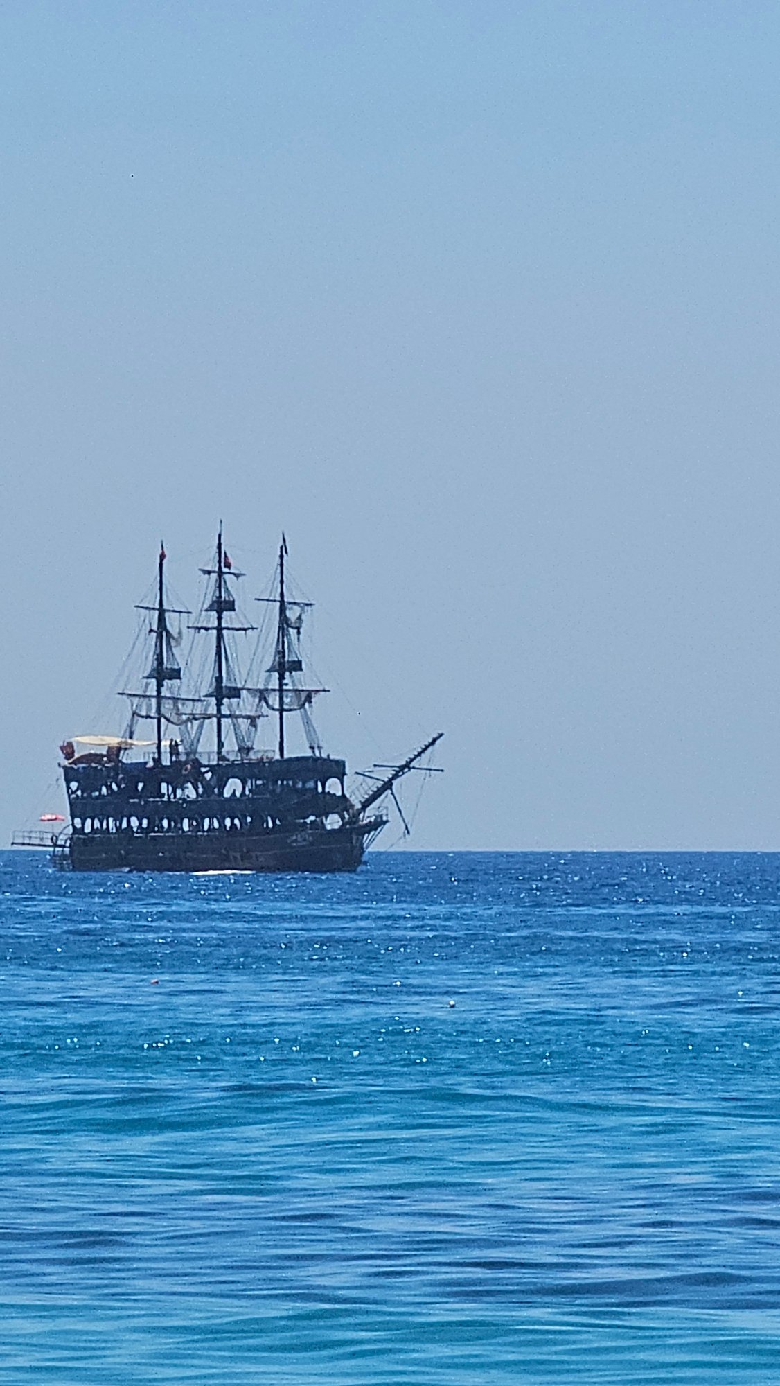 Alanya coastline in full summer swing — beach, sea, and sky.