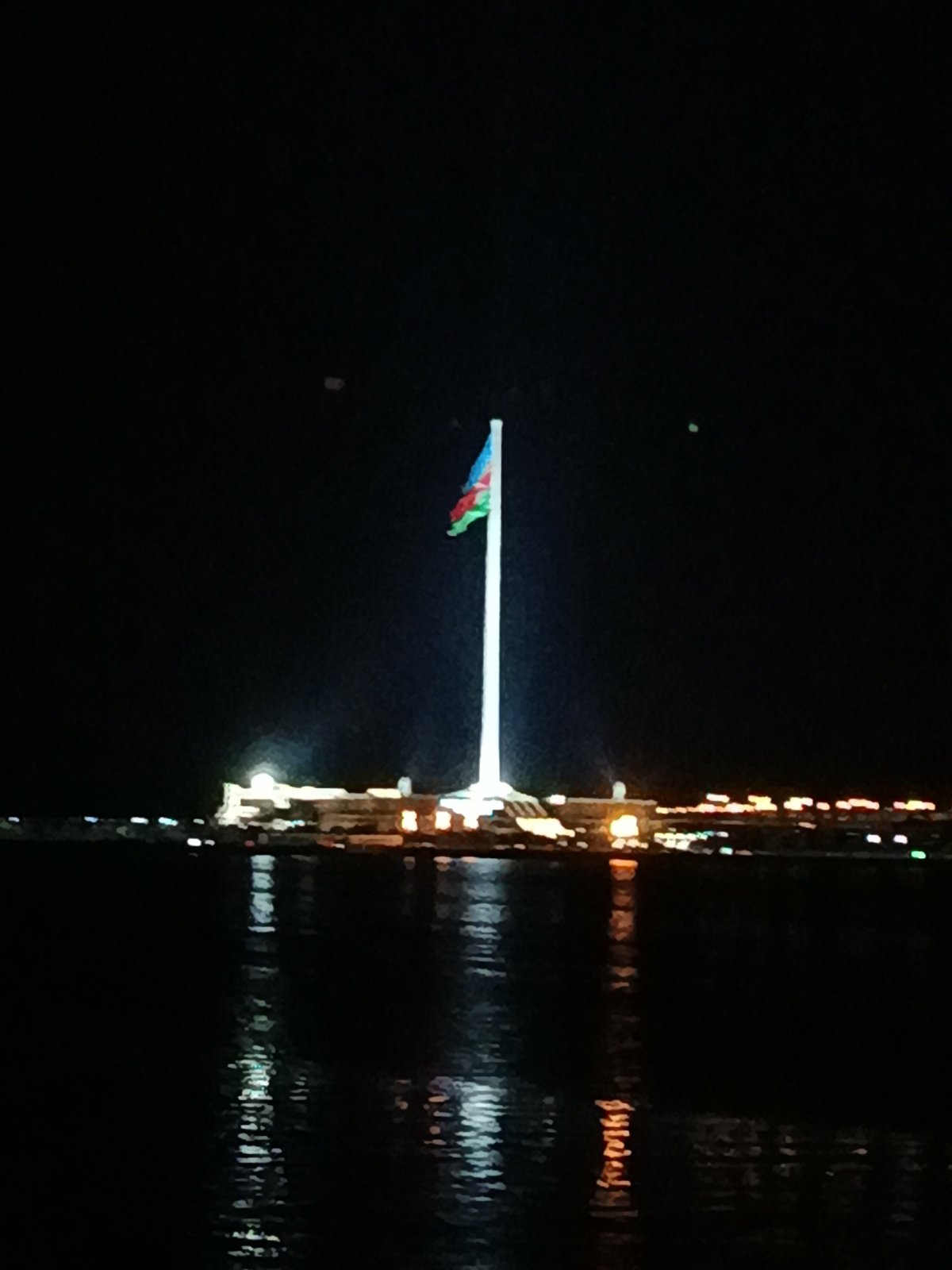 Baku Flagpole and Caspian skyline lit up at night