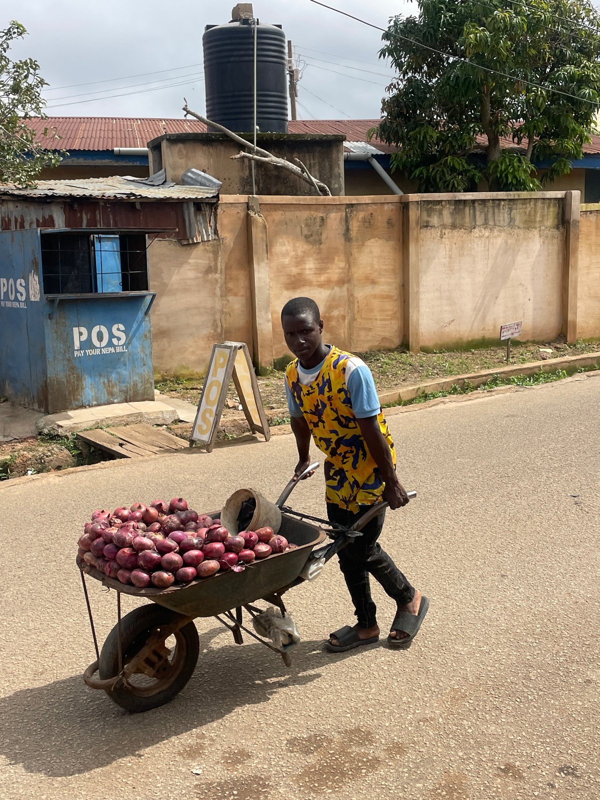 Morning street life across a Jos neighborhood
