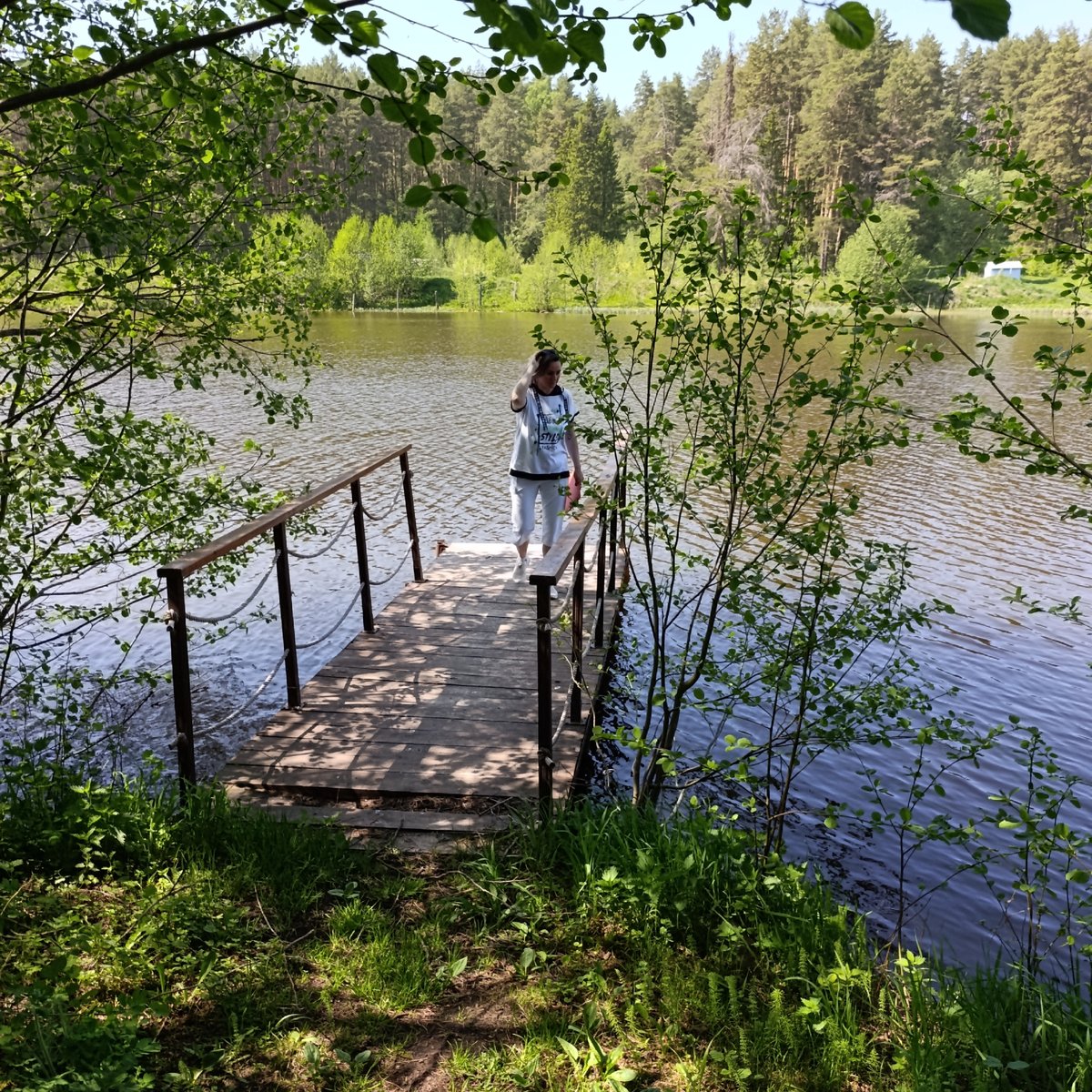 Woman enjoys morning lakeside activities in Prikamskii, Russia
