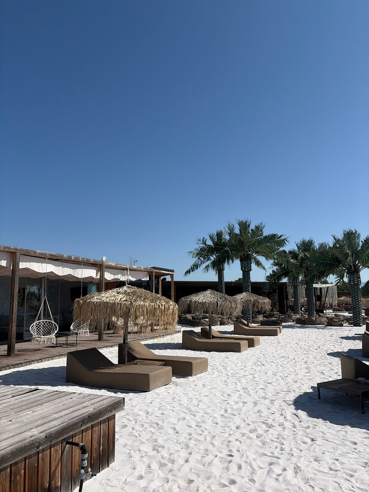 Sunny resort scenes: pool, sand, and lounge chairs in Bulgaria