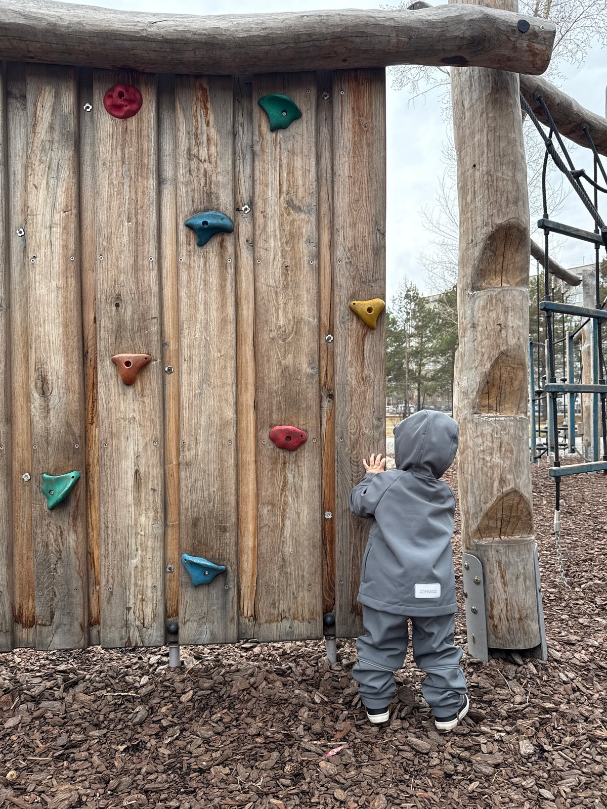 Child climbs playground wall in Krasnoyarsk