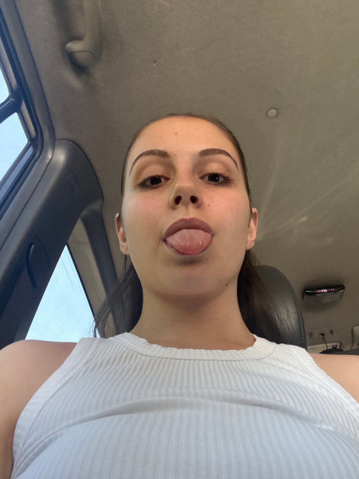 Woman takes playful selfies during vehicle travel in Burgas