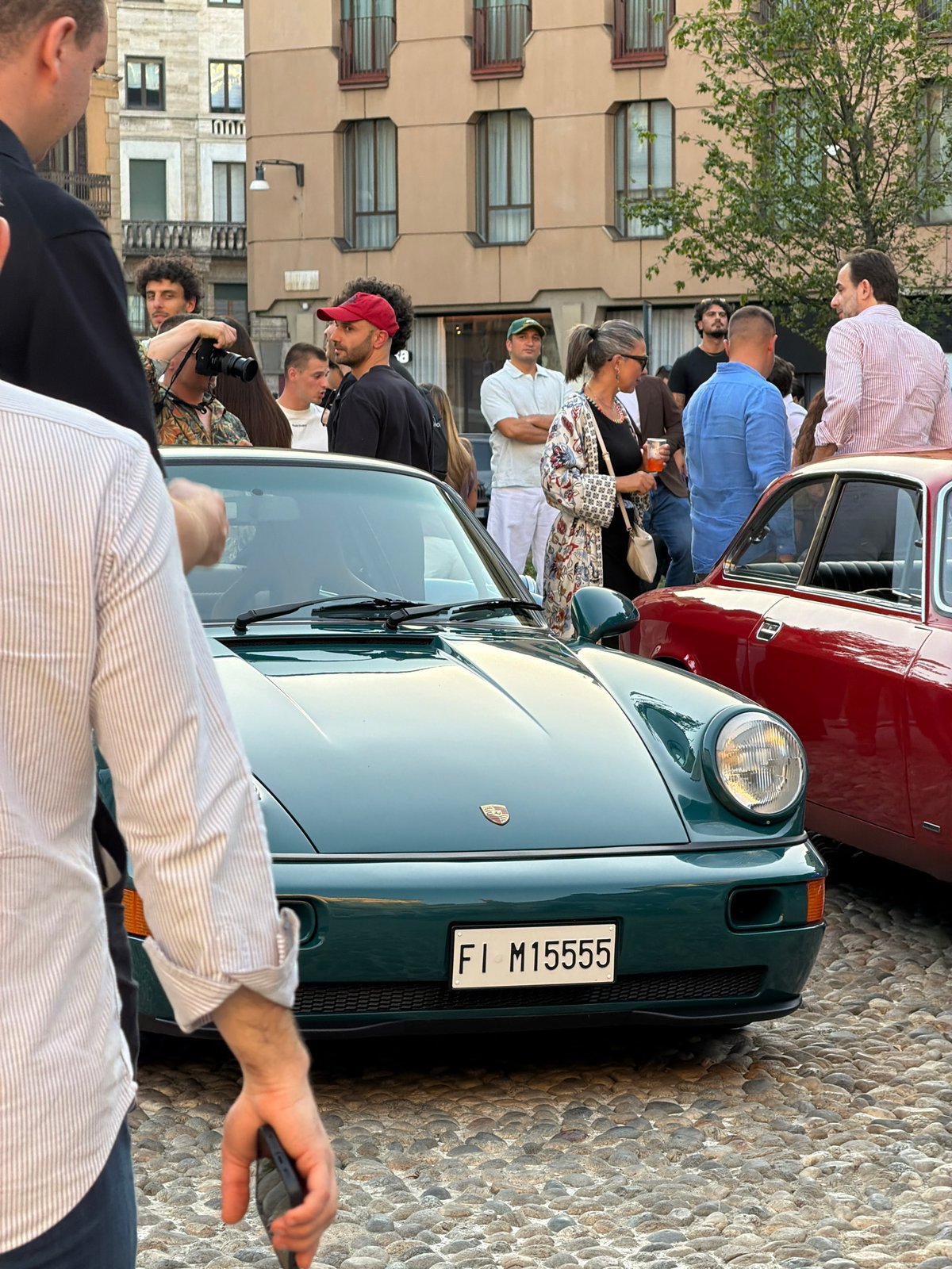 Vintage car meetup outside a European church with live DJ
