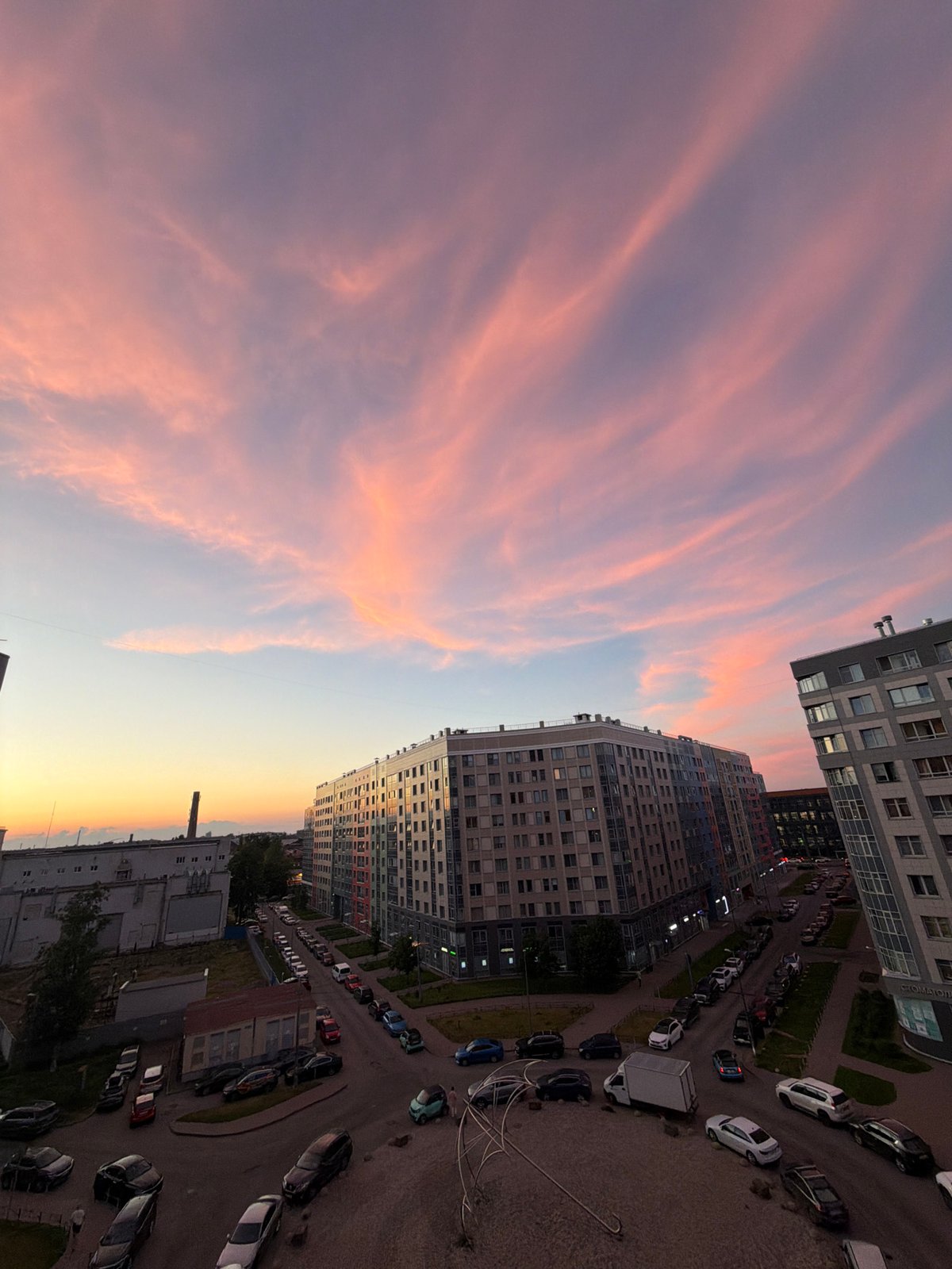 Summer solstice evening across a Russian city, cat included