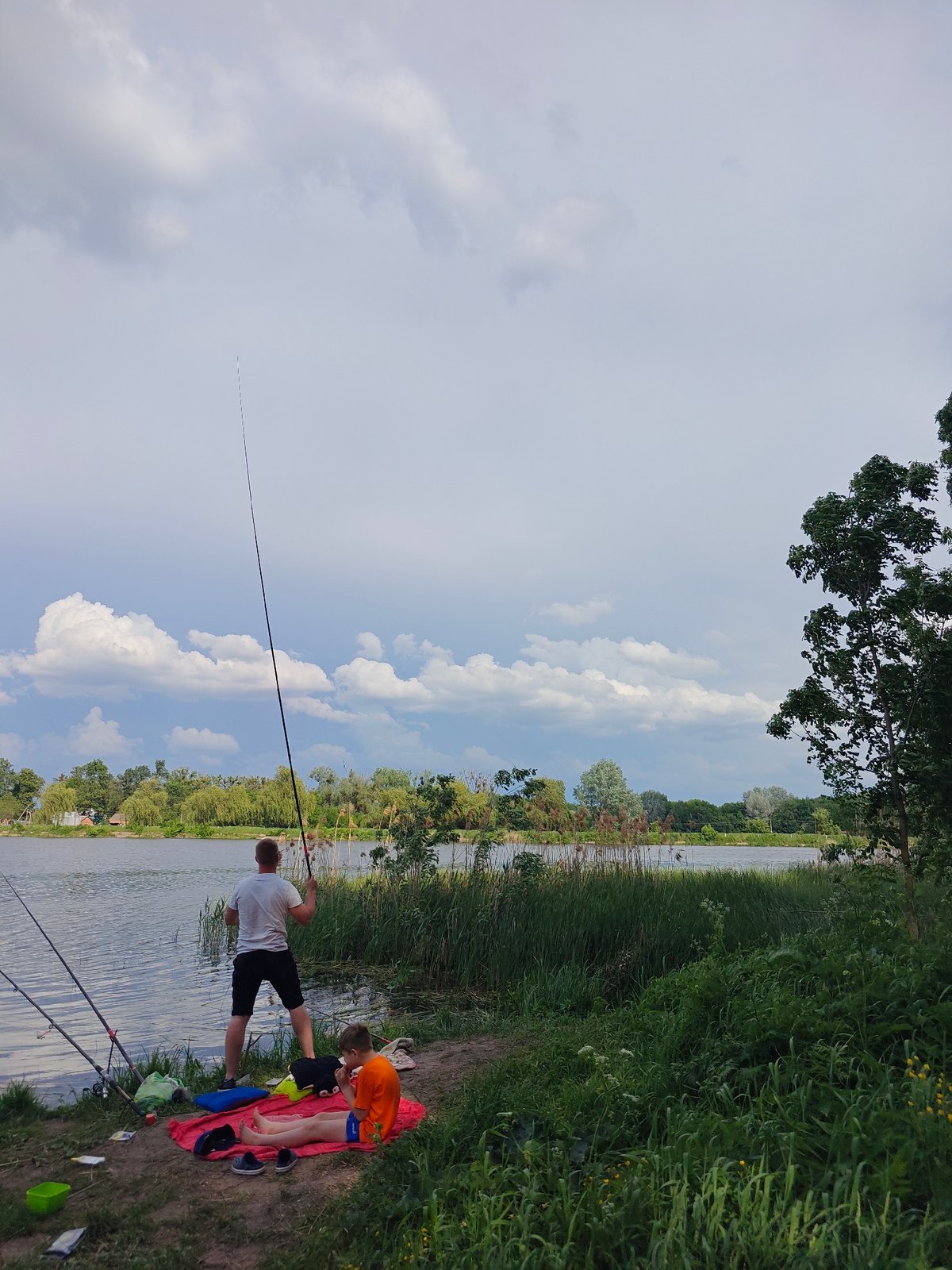 Father and son fishing trip at Ukrainian lake