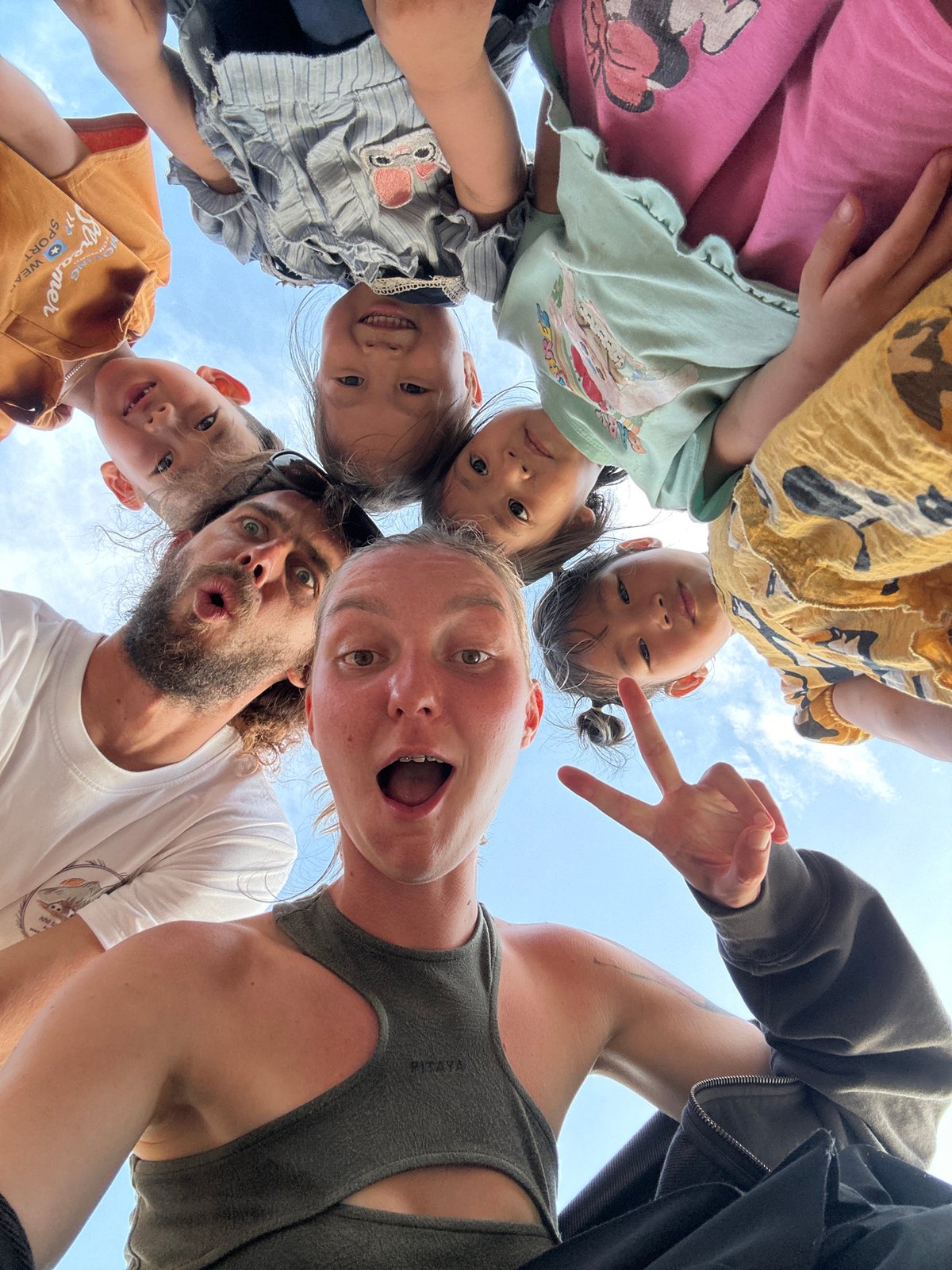 Family group gathers for playful photos in rural Vietnam