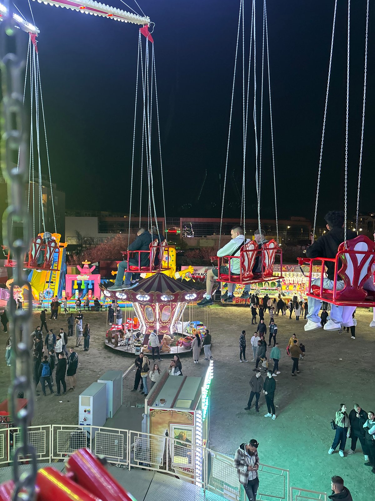 Swing carousel operates at Plovdiv amusement park during evening hours