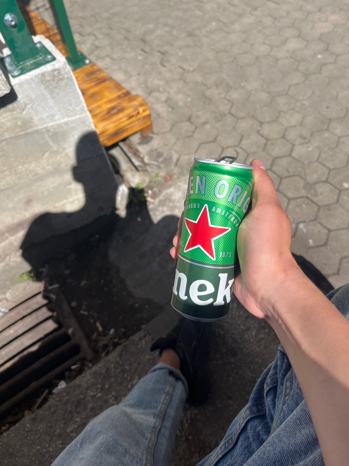 Person enjoys beer outside Sofia food establishment