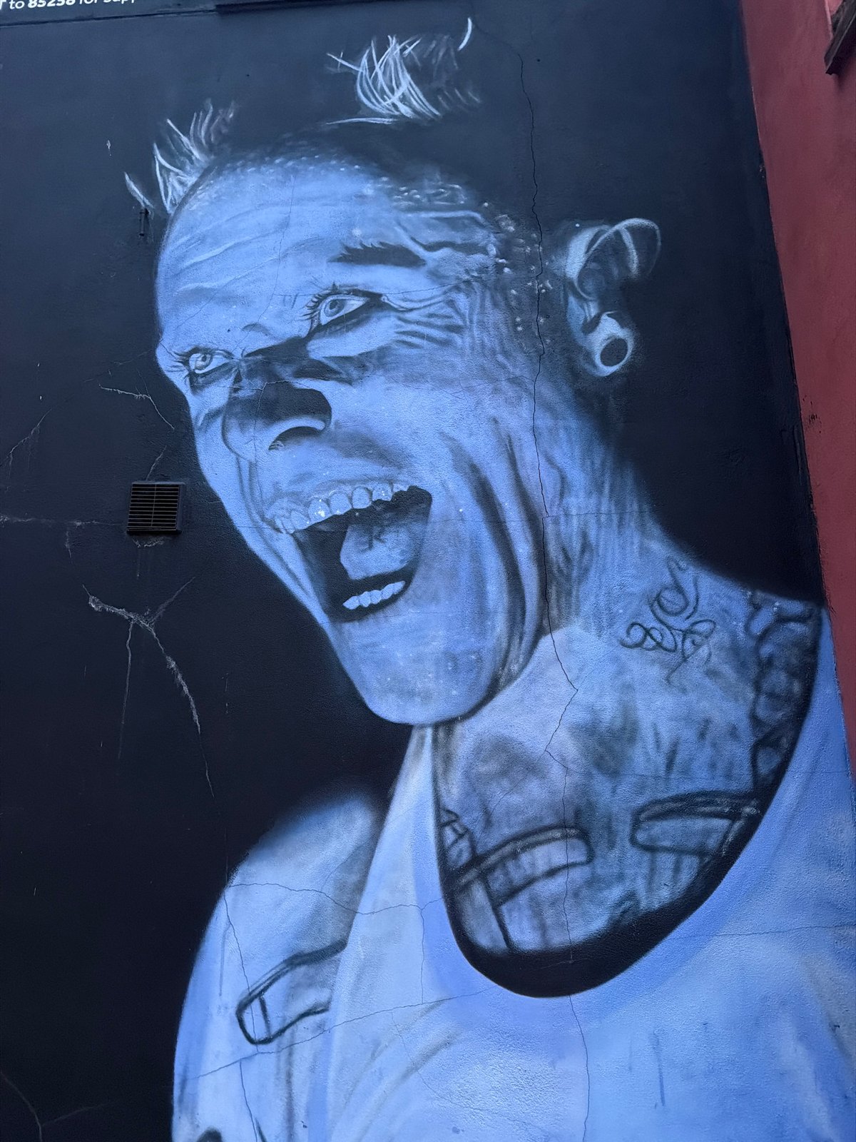 Distressed face mural spotted on London wall