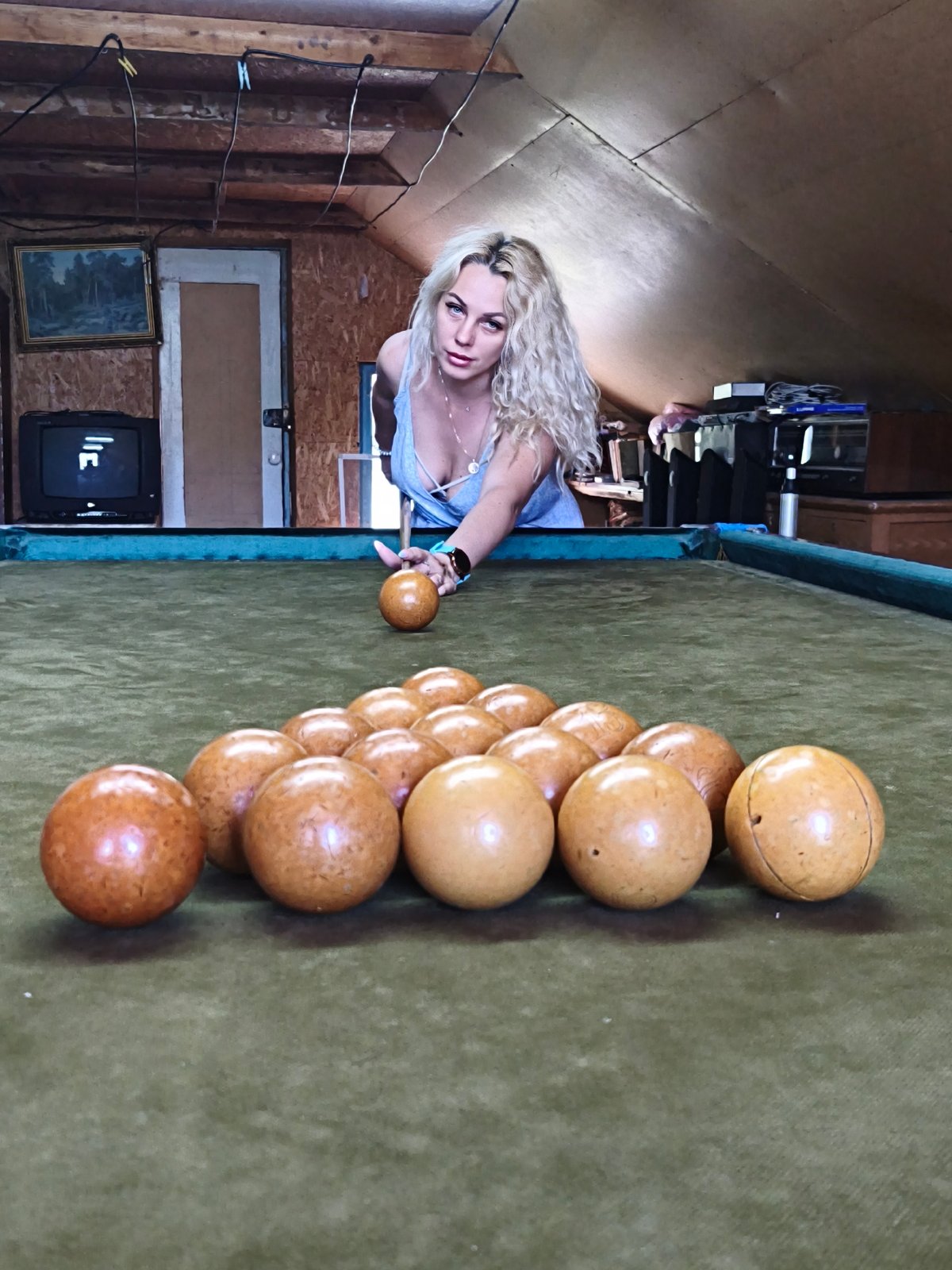 Woman plays billiards, flowers bloom in Ukrainian district