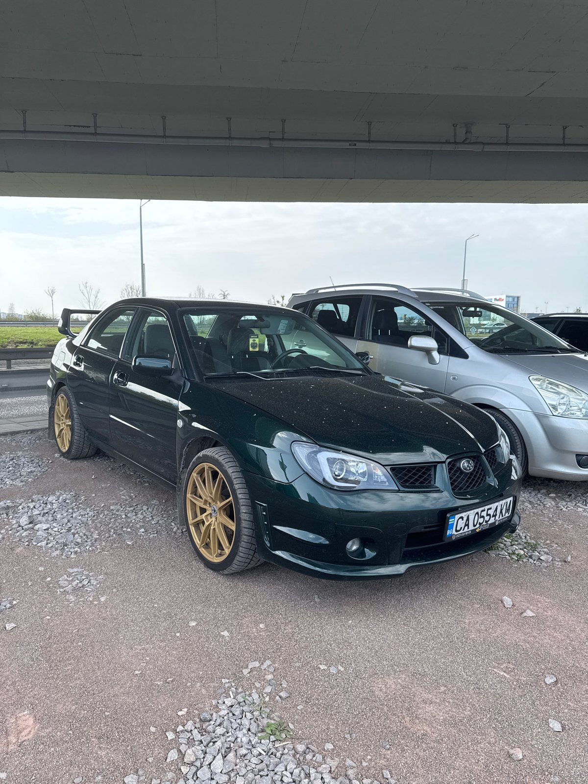 Green Subaru with gold rims spotted under Sofia overpass