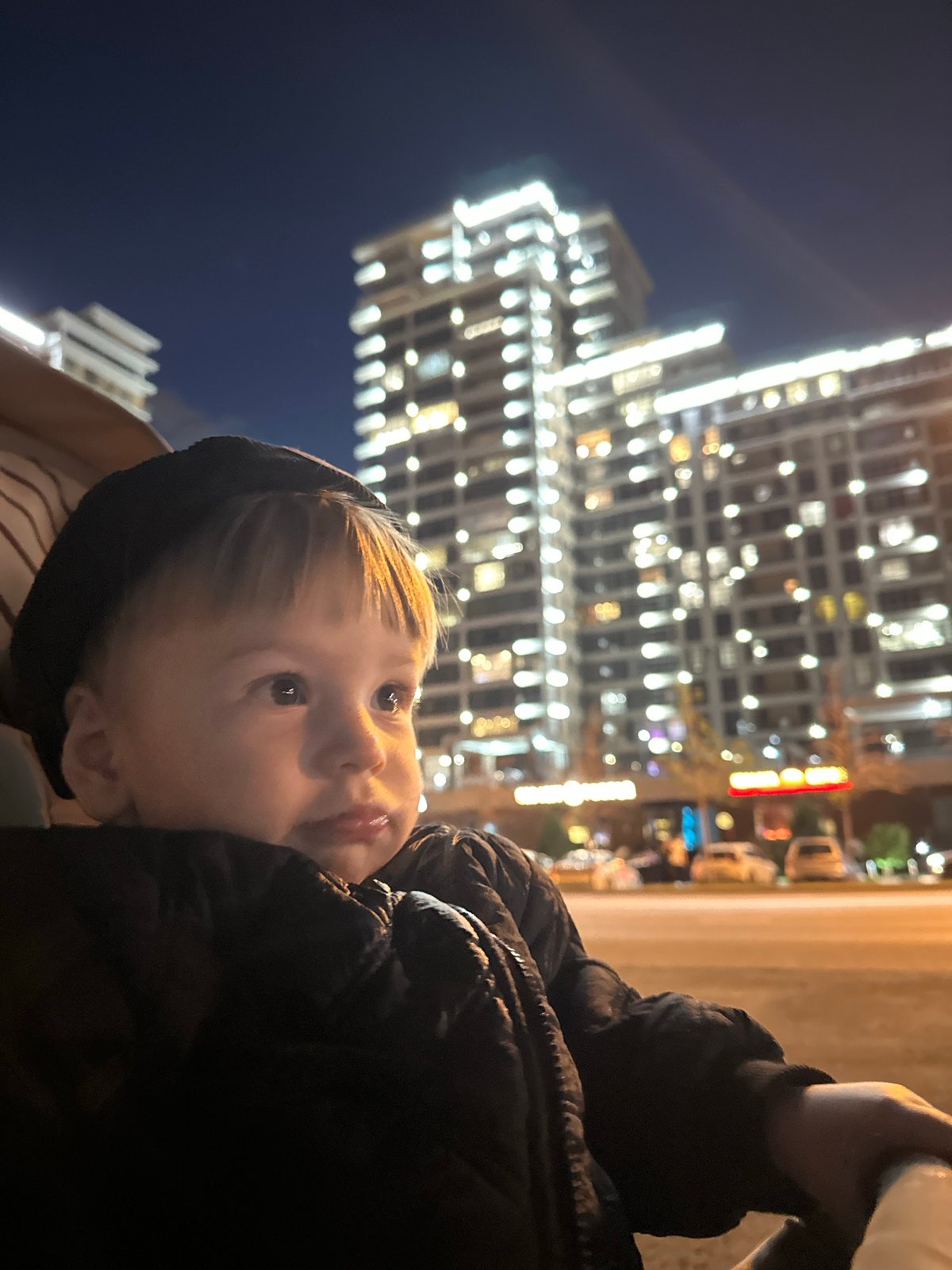 Child in hooded jacket spotted looking upward in Kazan
