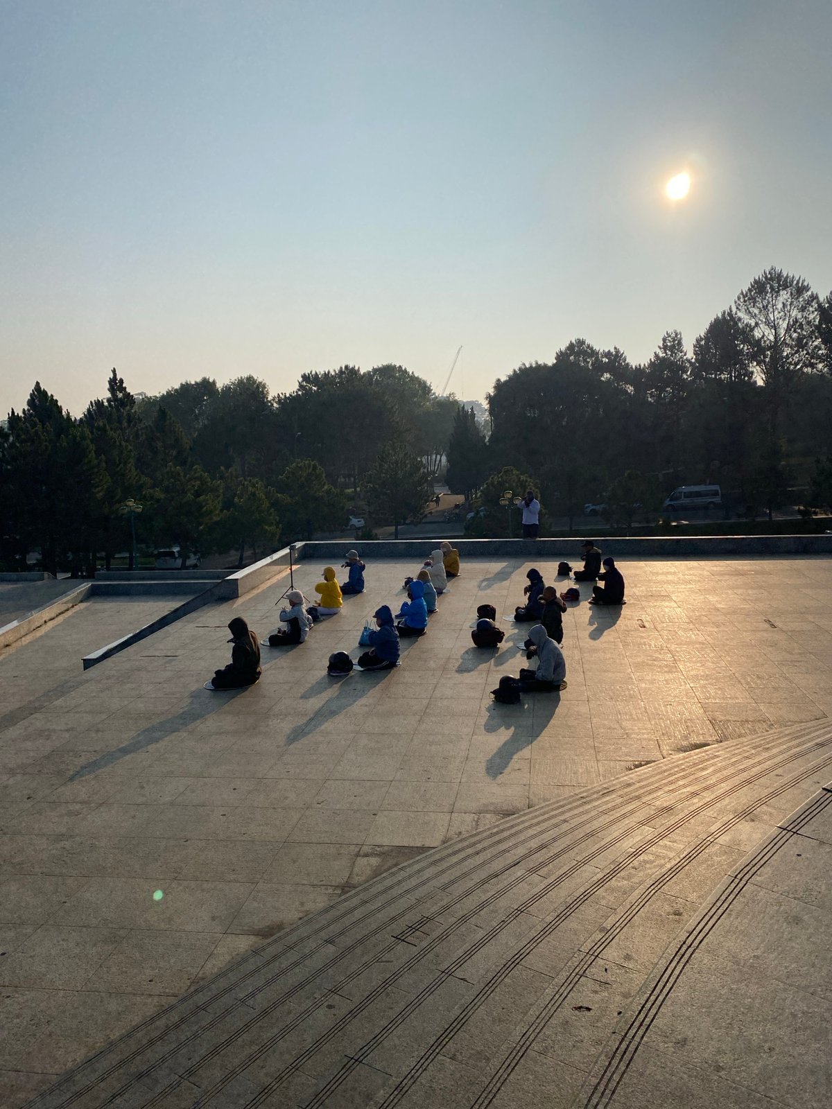 Group performs synchronized bowing movements on Da Lat plaza