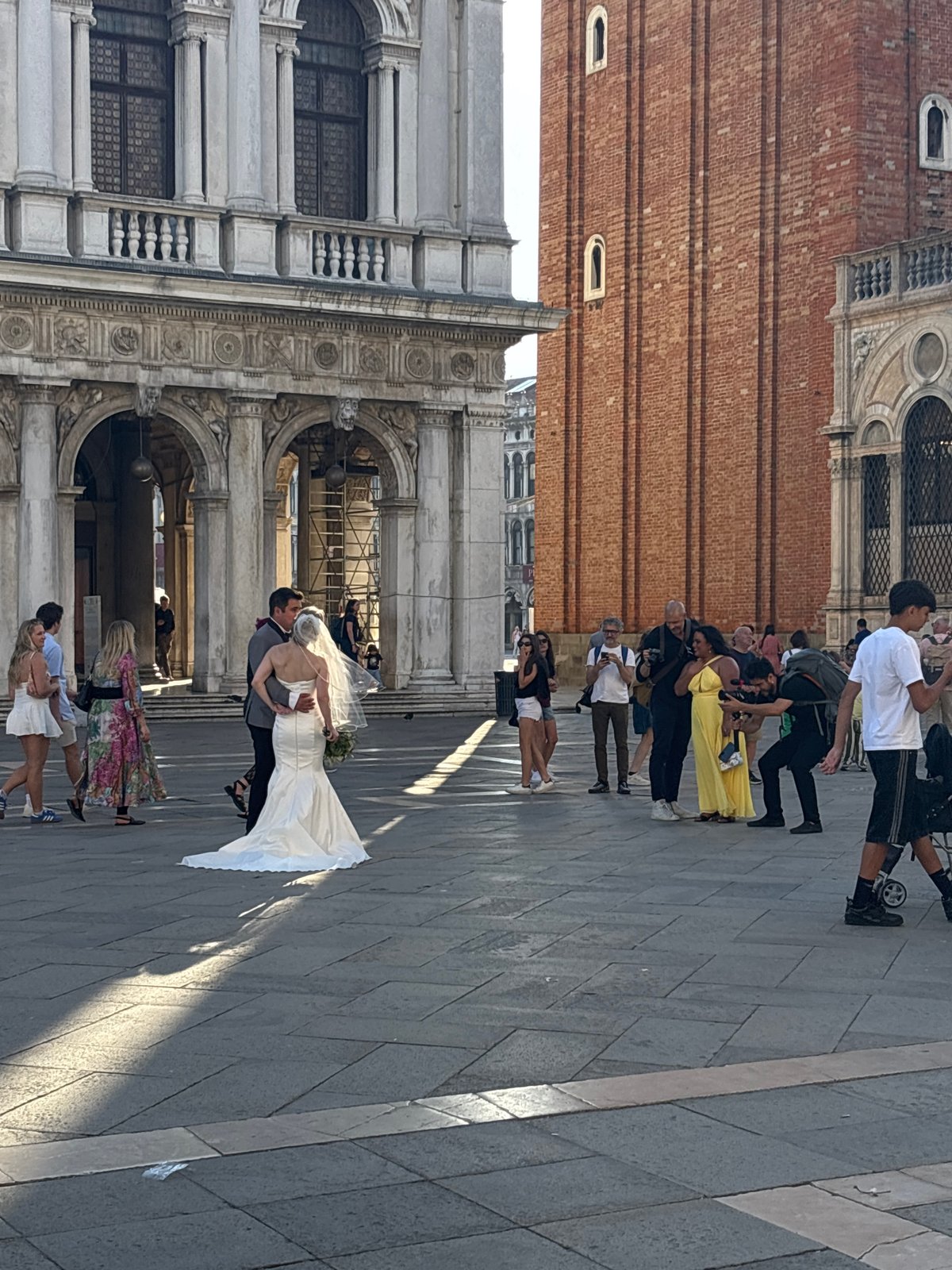 Wedding couple embraces in Venice's St. Mark's Square