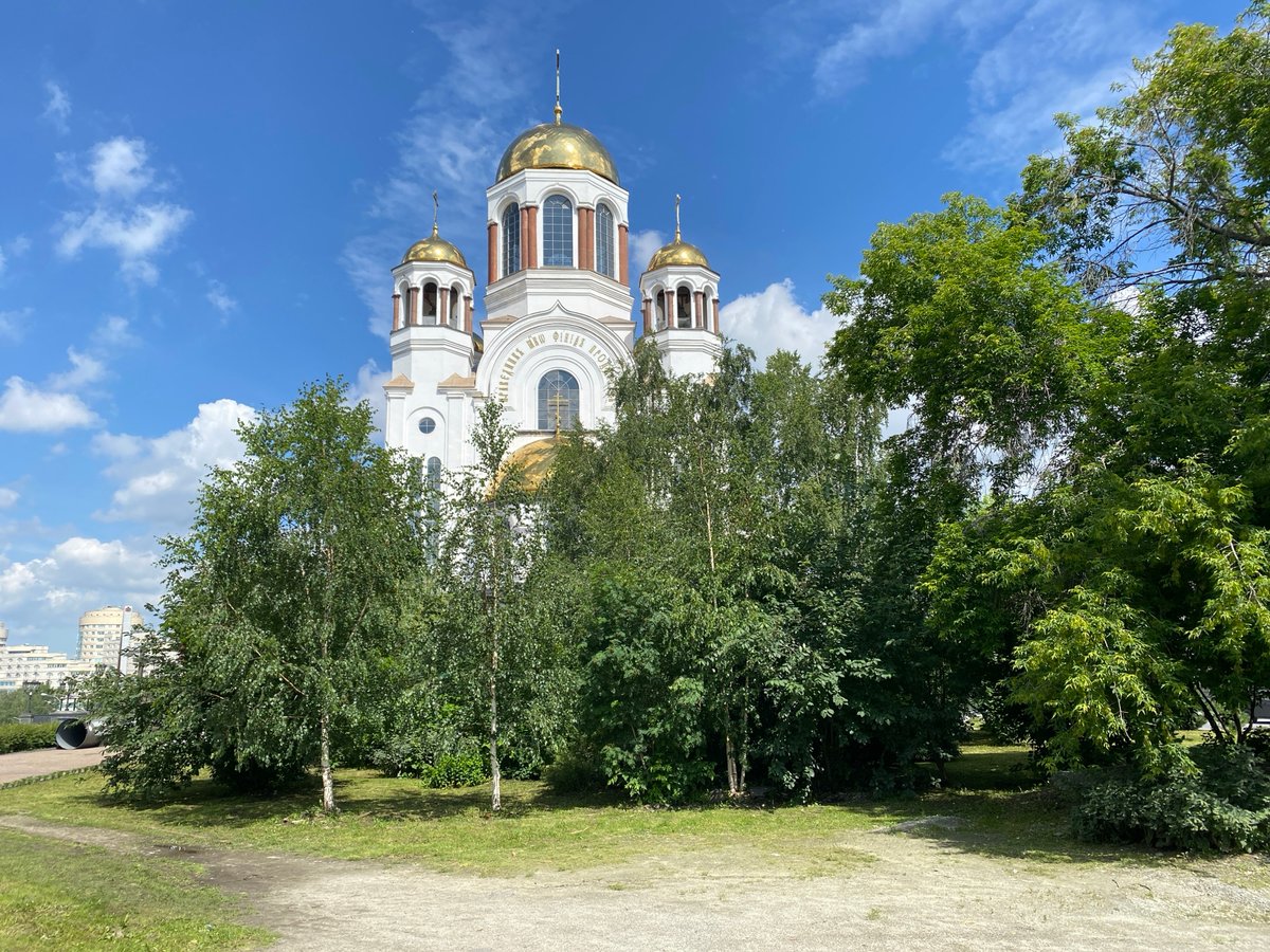 Street-level look at Yekaterinburg's churches, trams, and skyline