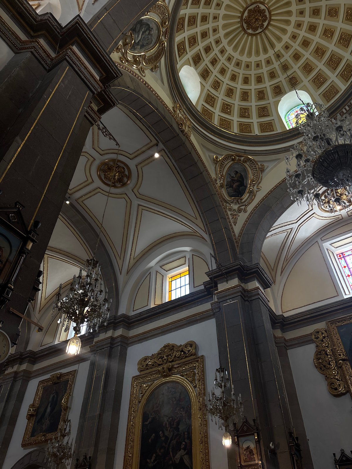 Visitor documents ornate church interiors in historic Puebla, Mexico