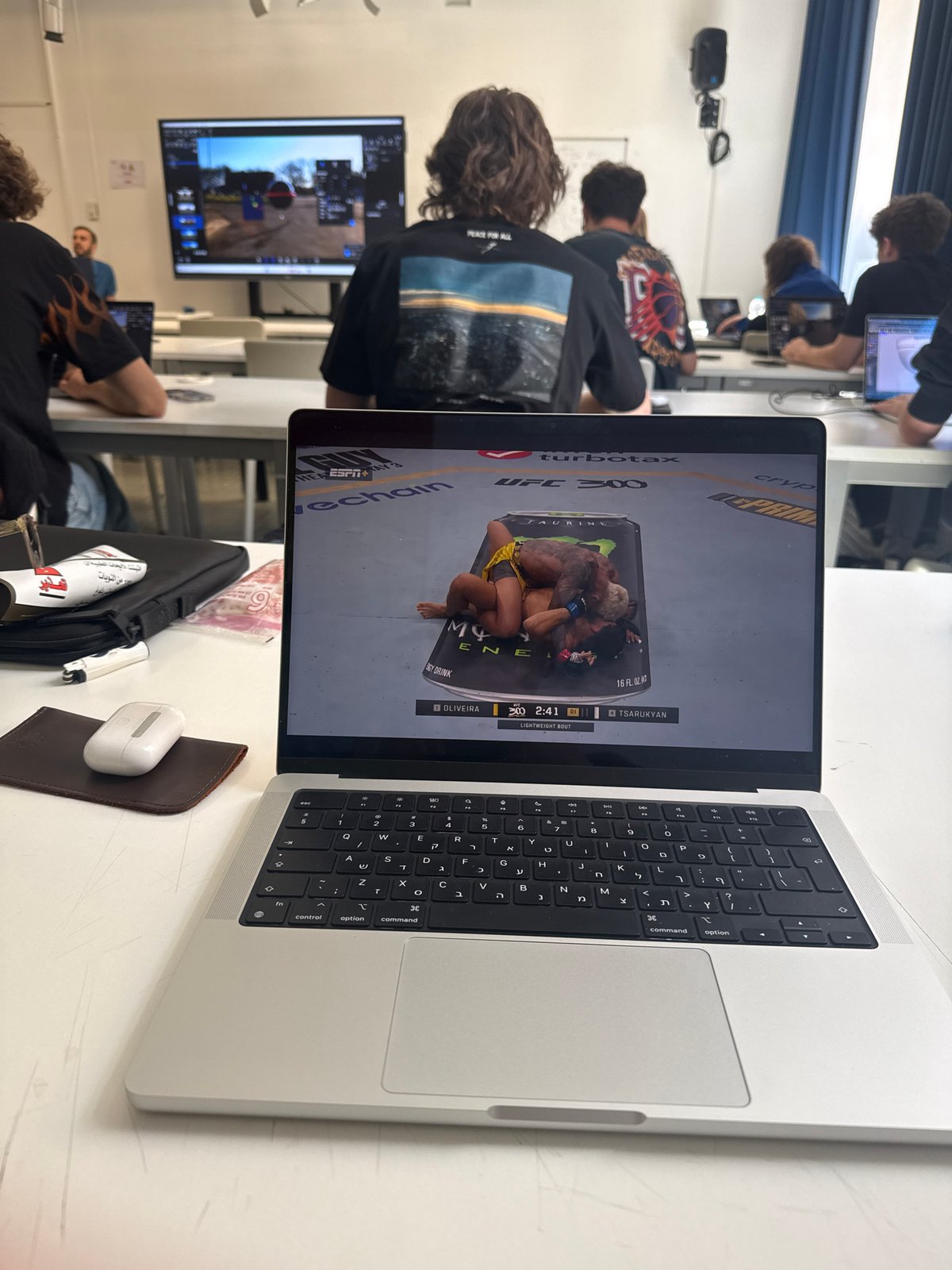 Student watches UFC fight on laptop during Milan classroom session