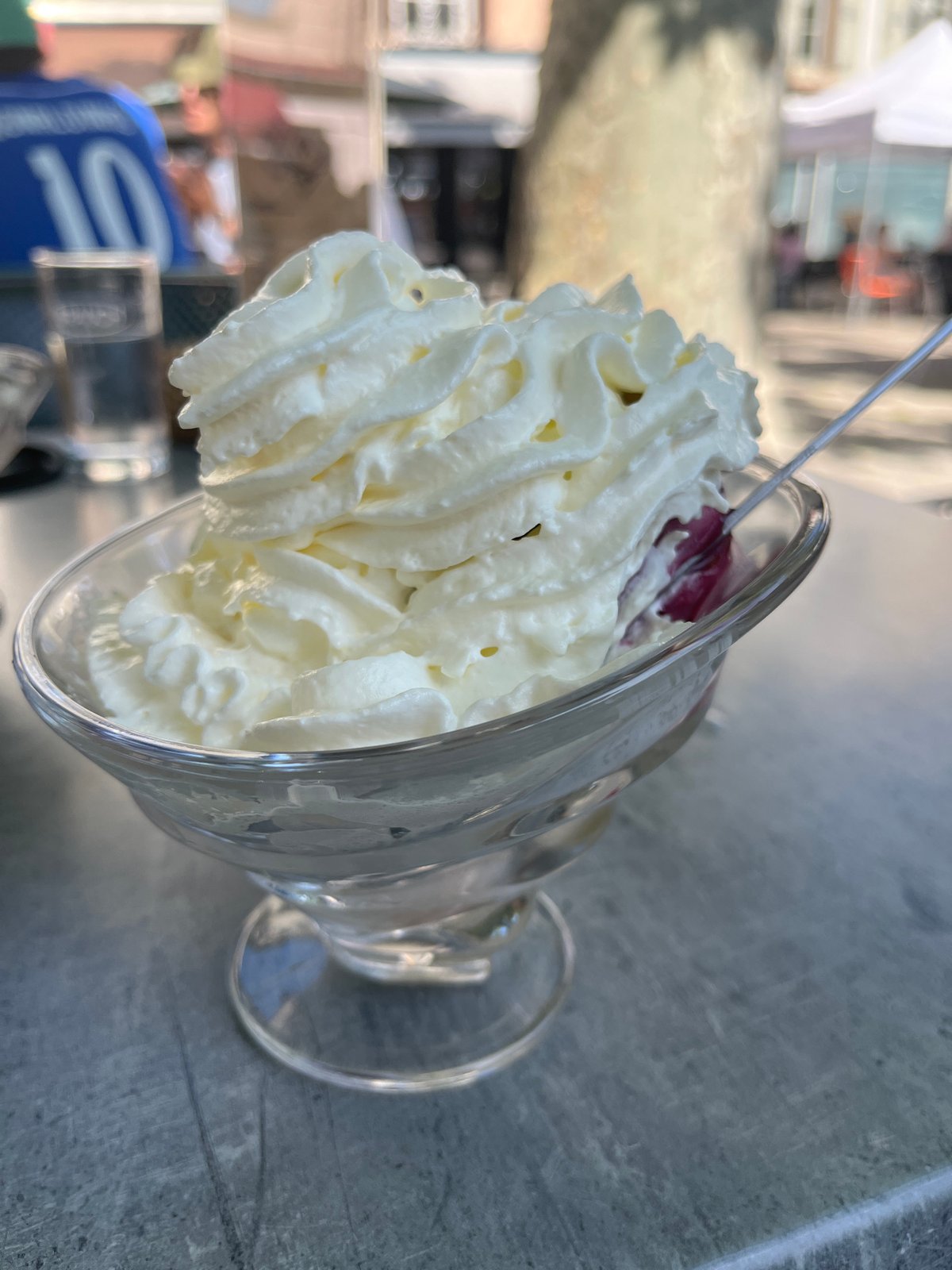 Woman enjoys dessert at outdoor cafe in Montbrison
