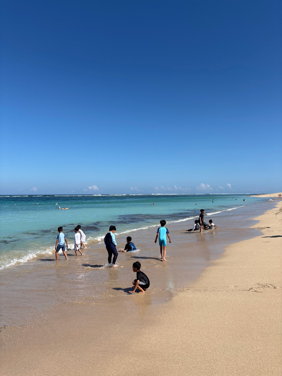 Woman enjoys morning ocean at Nusa Dua beach