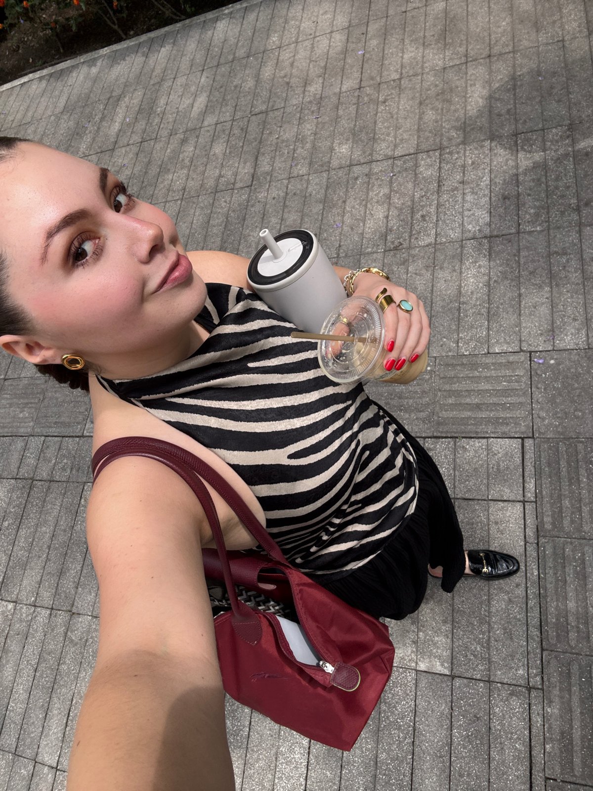 Woman with drink observed on Mexico City pedestrian walkway