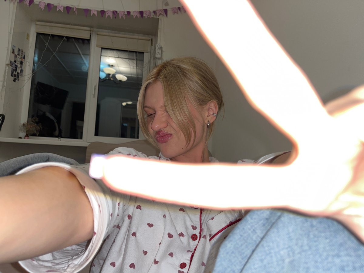 Woman Takes Multiple Selfies in Bedroom in Chaikovsky