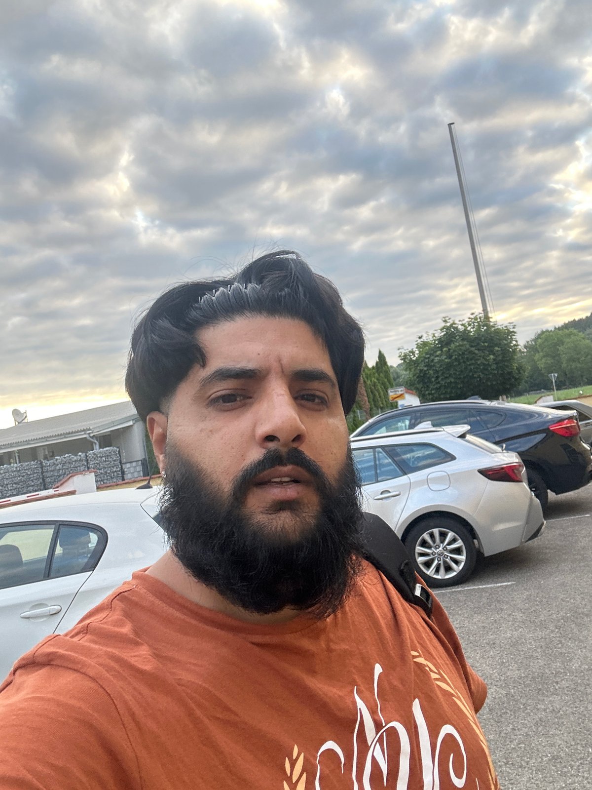 Outdoor selfie in a Mainburg parking lot, July 2026
