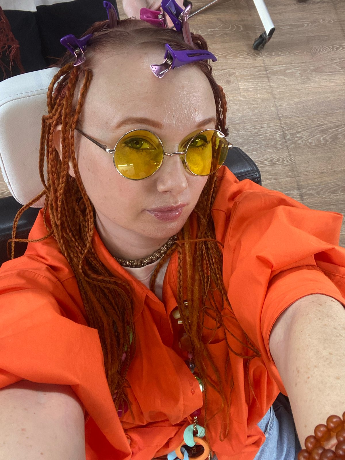 Woman documents dreadlock styling session at Sochi hair salon