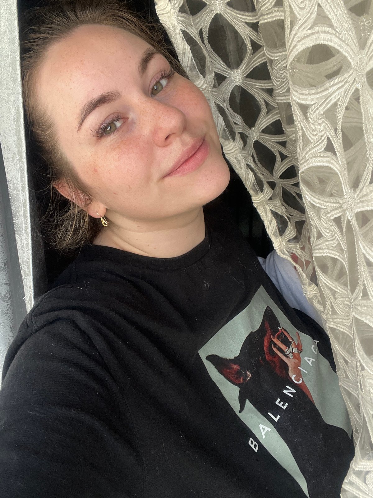 Woman in black t-shirt observed indoors in Chaikovsky