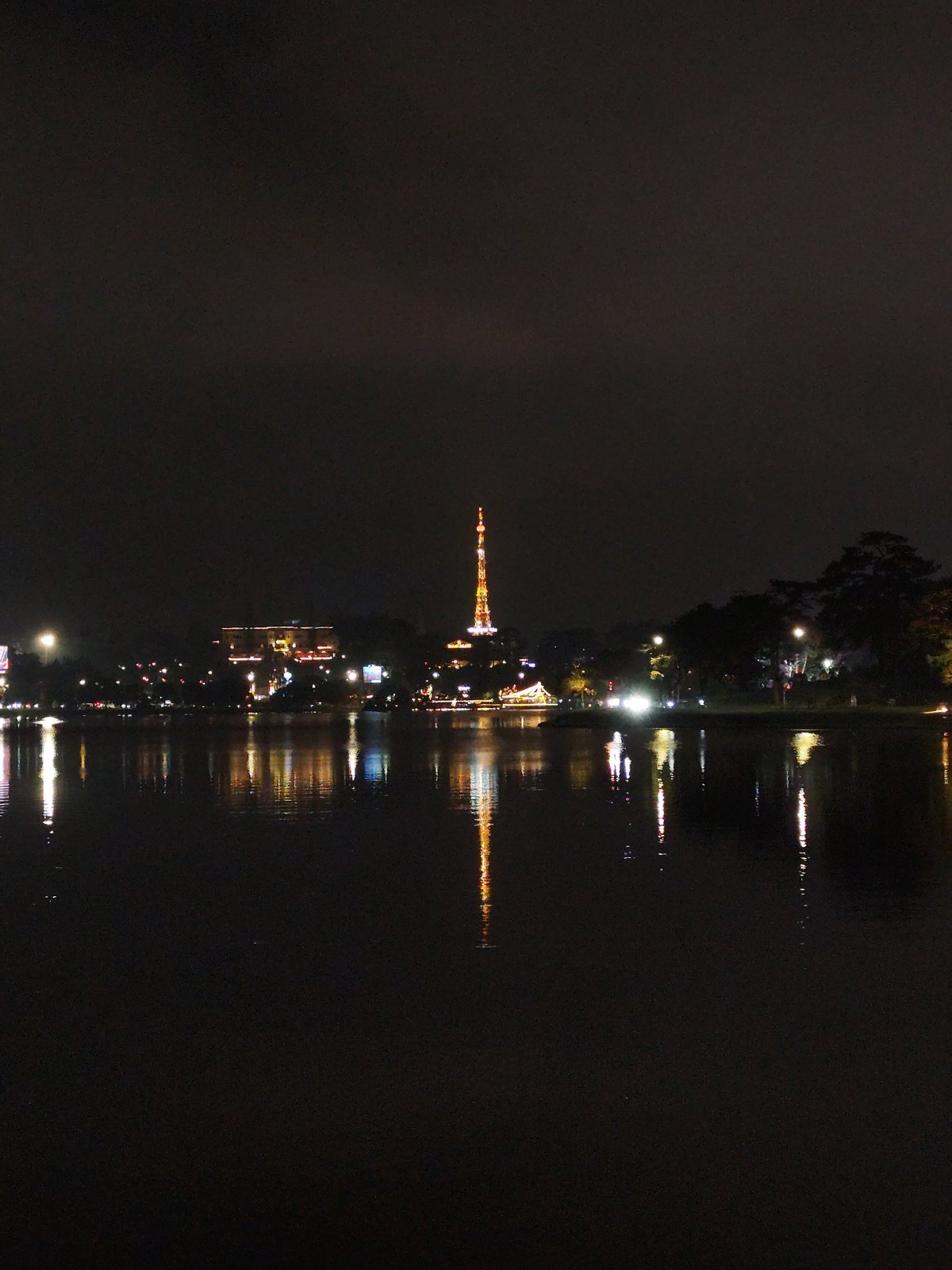 Nighttime lakeside gathering and street performance in Da Lat Vietnam