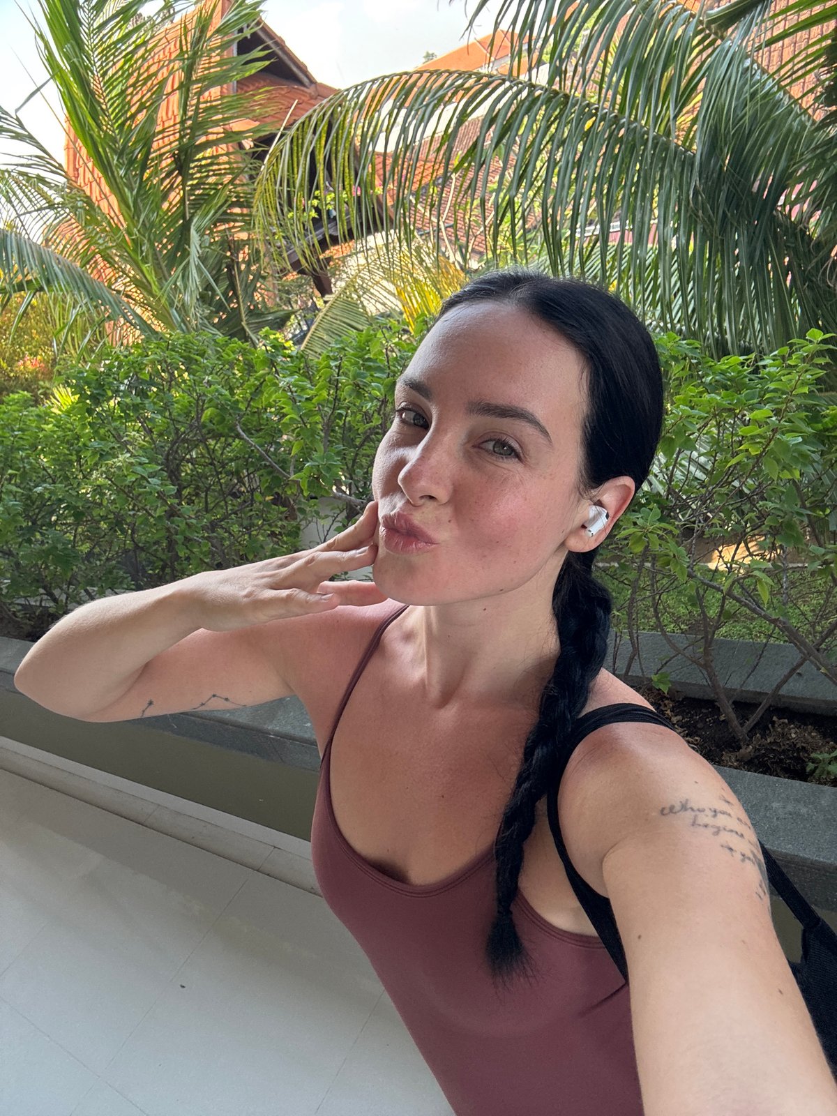 Quick Bali stop: plumeria, selfies, and a parked helmet