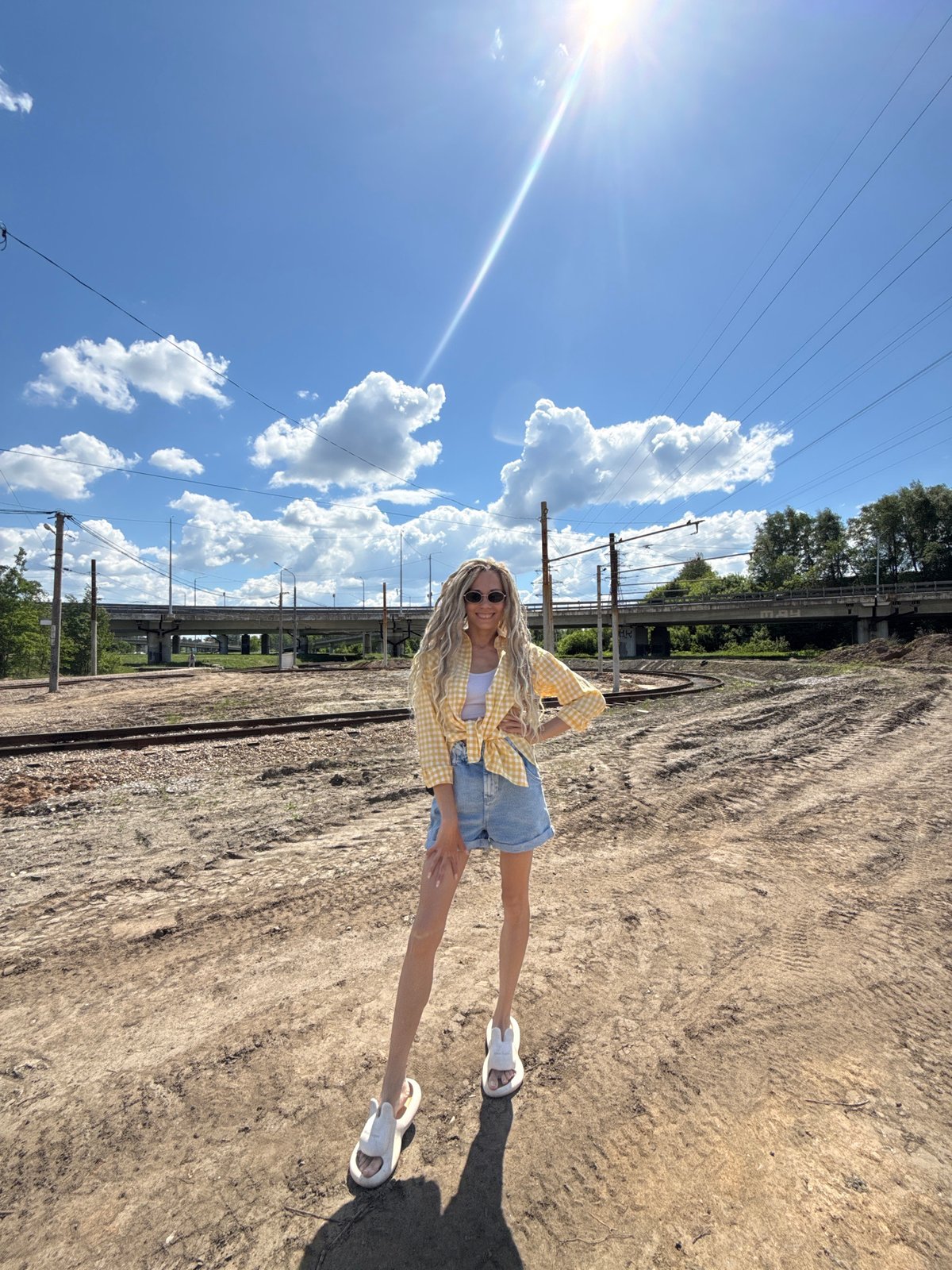 Woman poses for photos near railway tracks in Zavolzhye