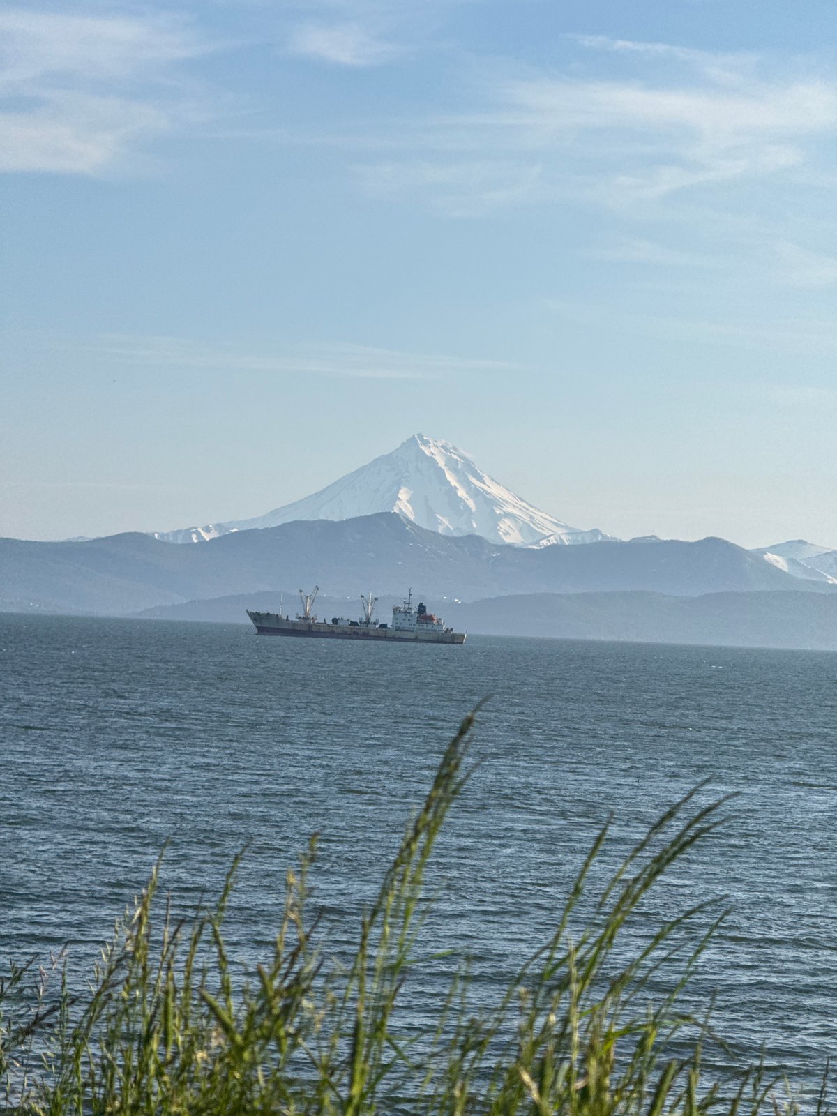 Historic cannons overlook Kamchatka bay with volcano backdrop