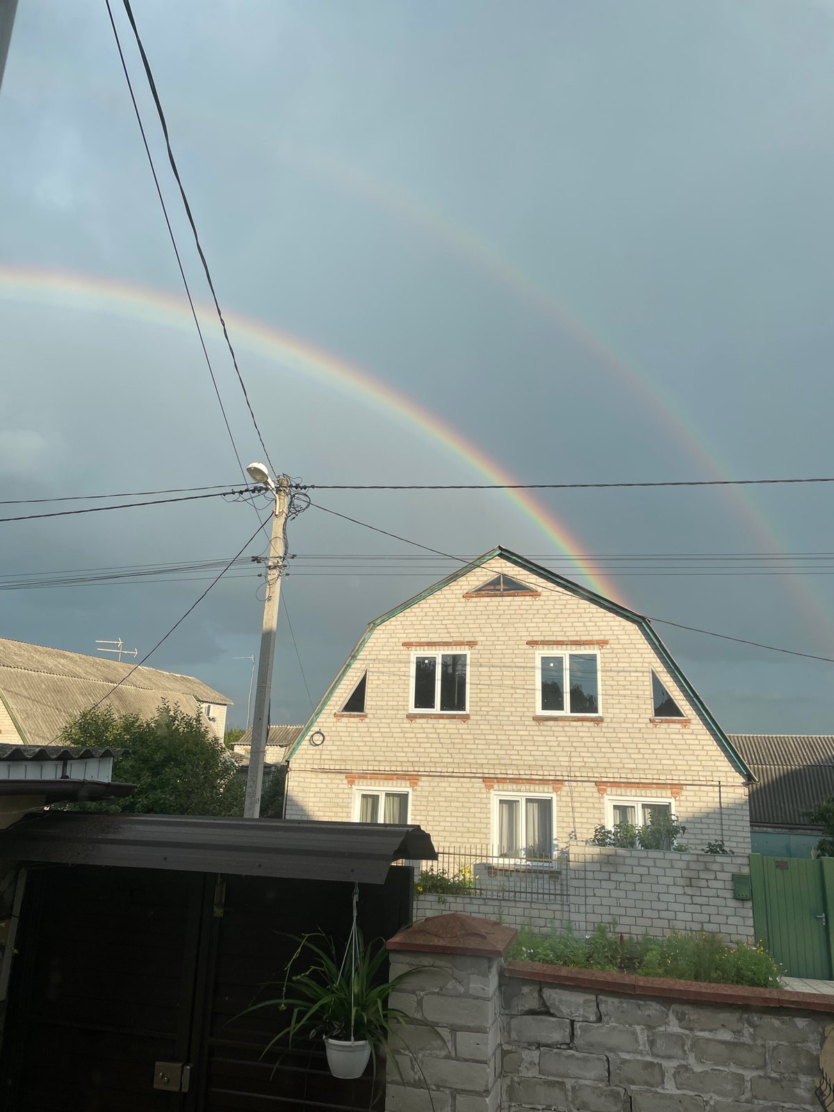Double rainbow over a quiet neighborhood in Vysokyi, Ukraine