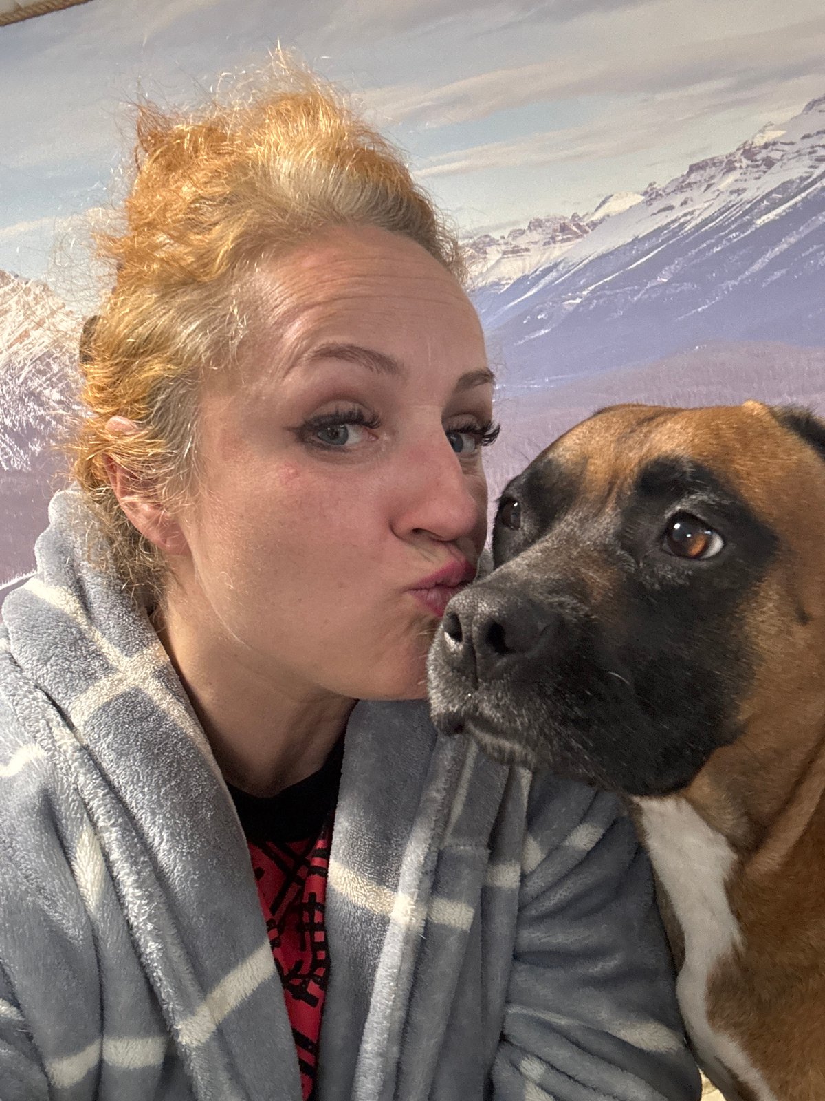 Woman and boxer dog share quiet moments in Chaikovsky