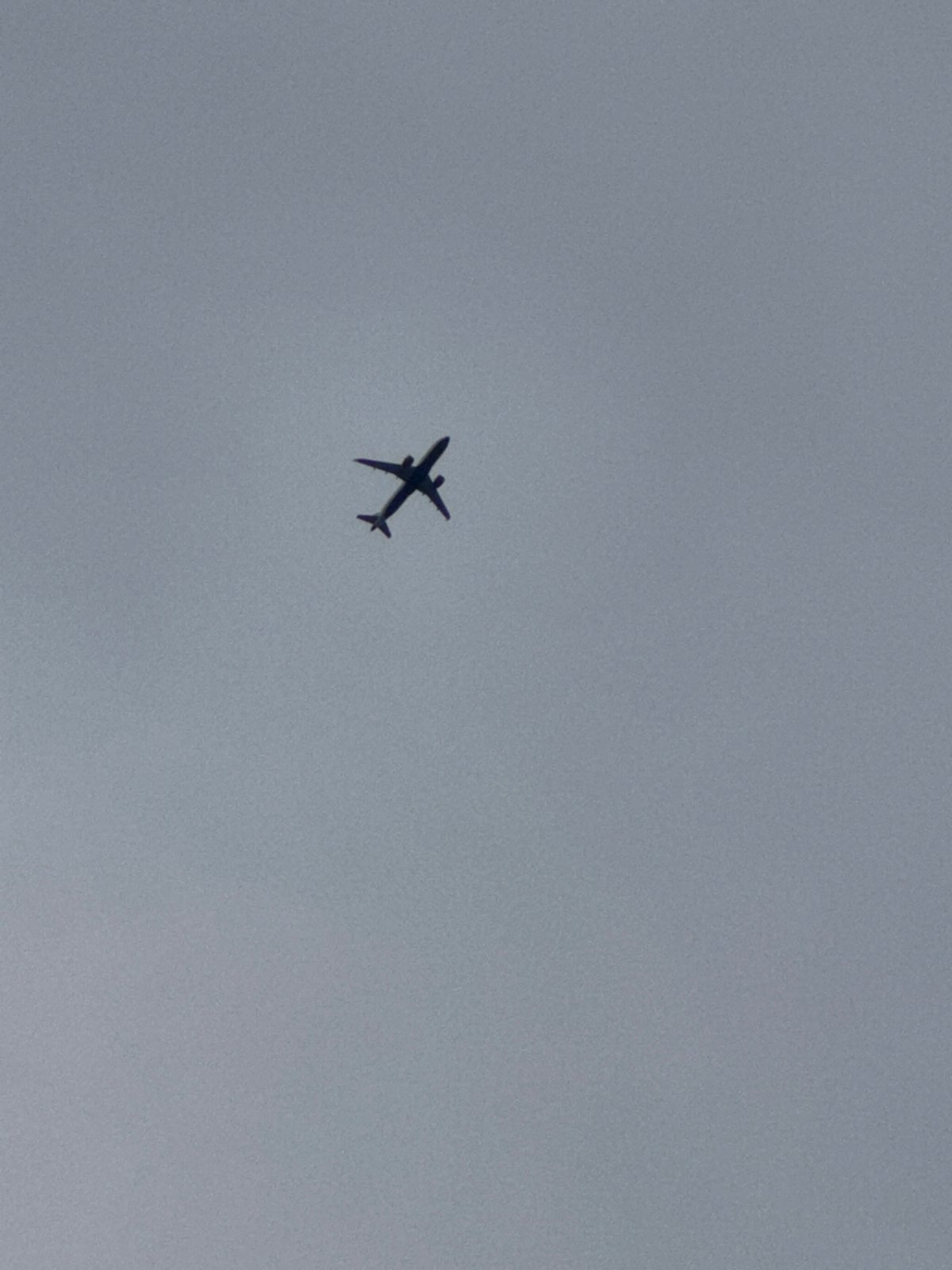 Commercial flight passing overhead, London skies, July evening