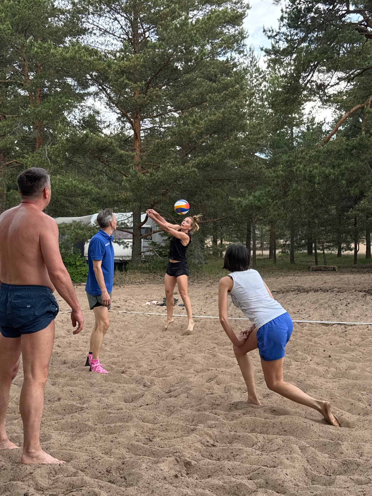 Beach volleyball game played in pine forest, Zelenaya Roshcha