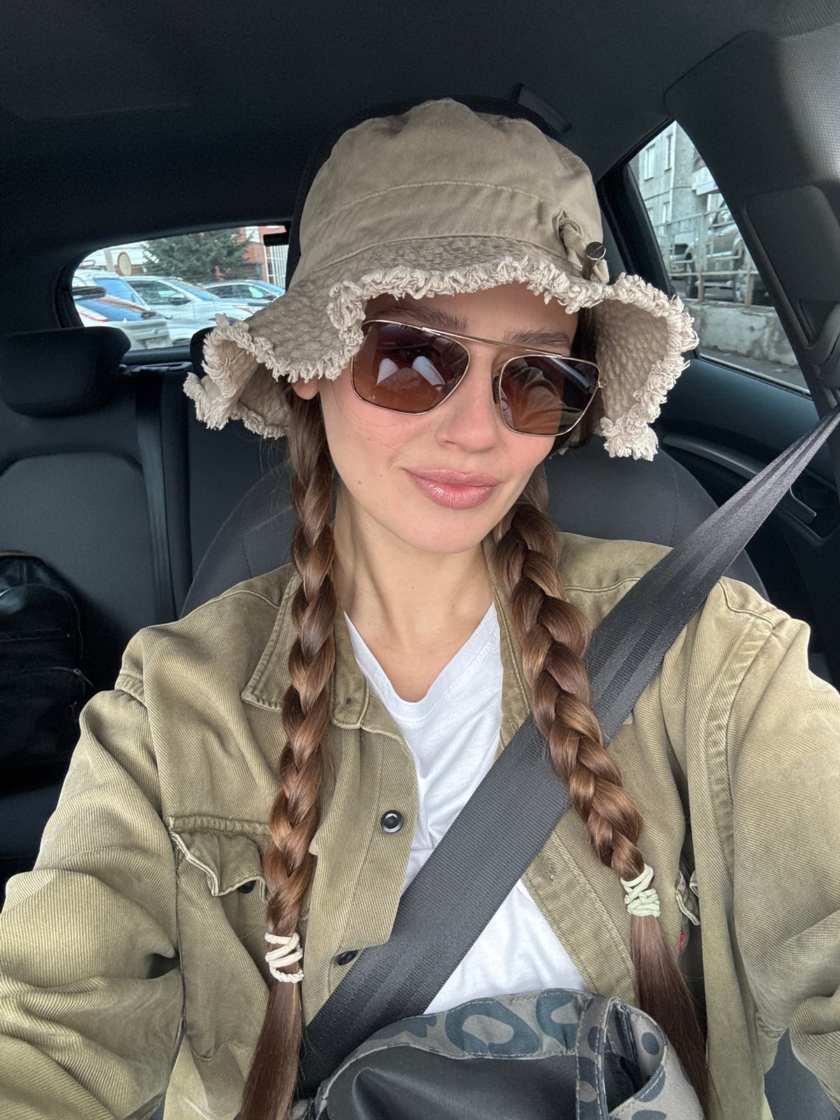 Woman takes car selfie in Krasnoyarsk wearing bucket hat