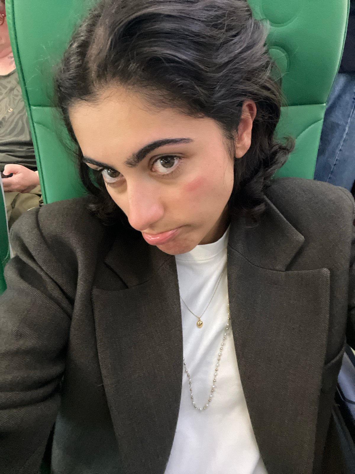 Woman rests on green seat in Sant Josep de sa Talaia