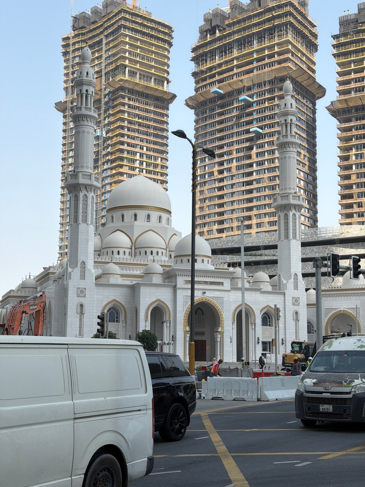 White mosque stands amid Dubai's ongoing high-rise construction
