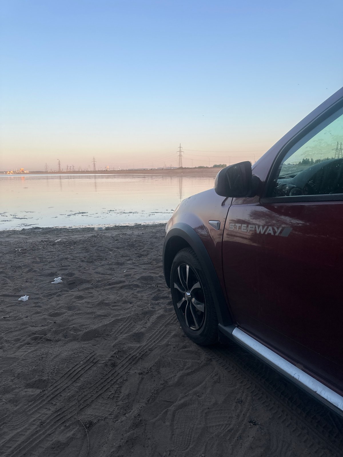 Maroon Dacia parked near water in Noviy, Russia