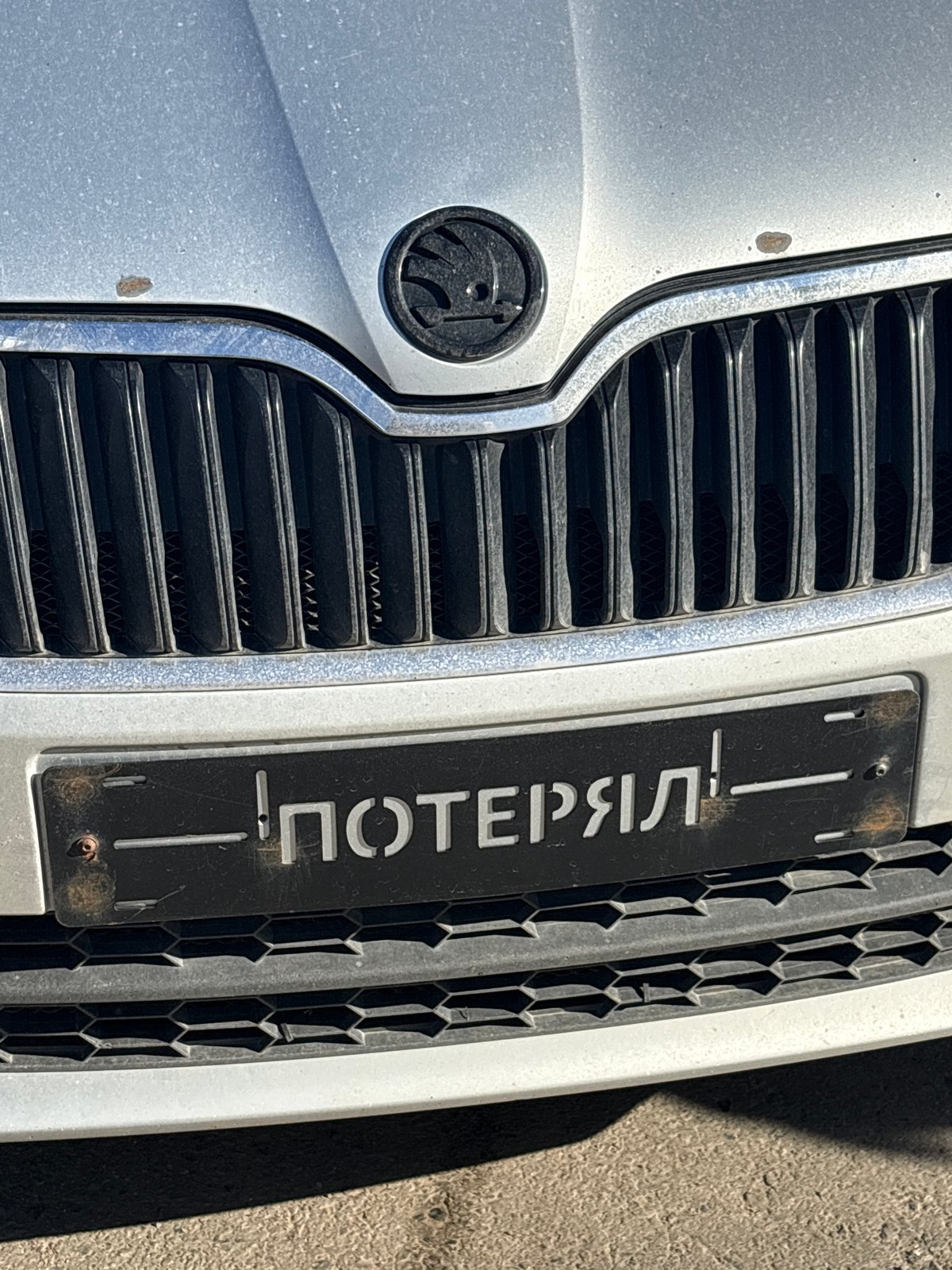 Dusty silver car photographed in Izhevsk, Russia