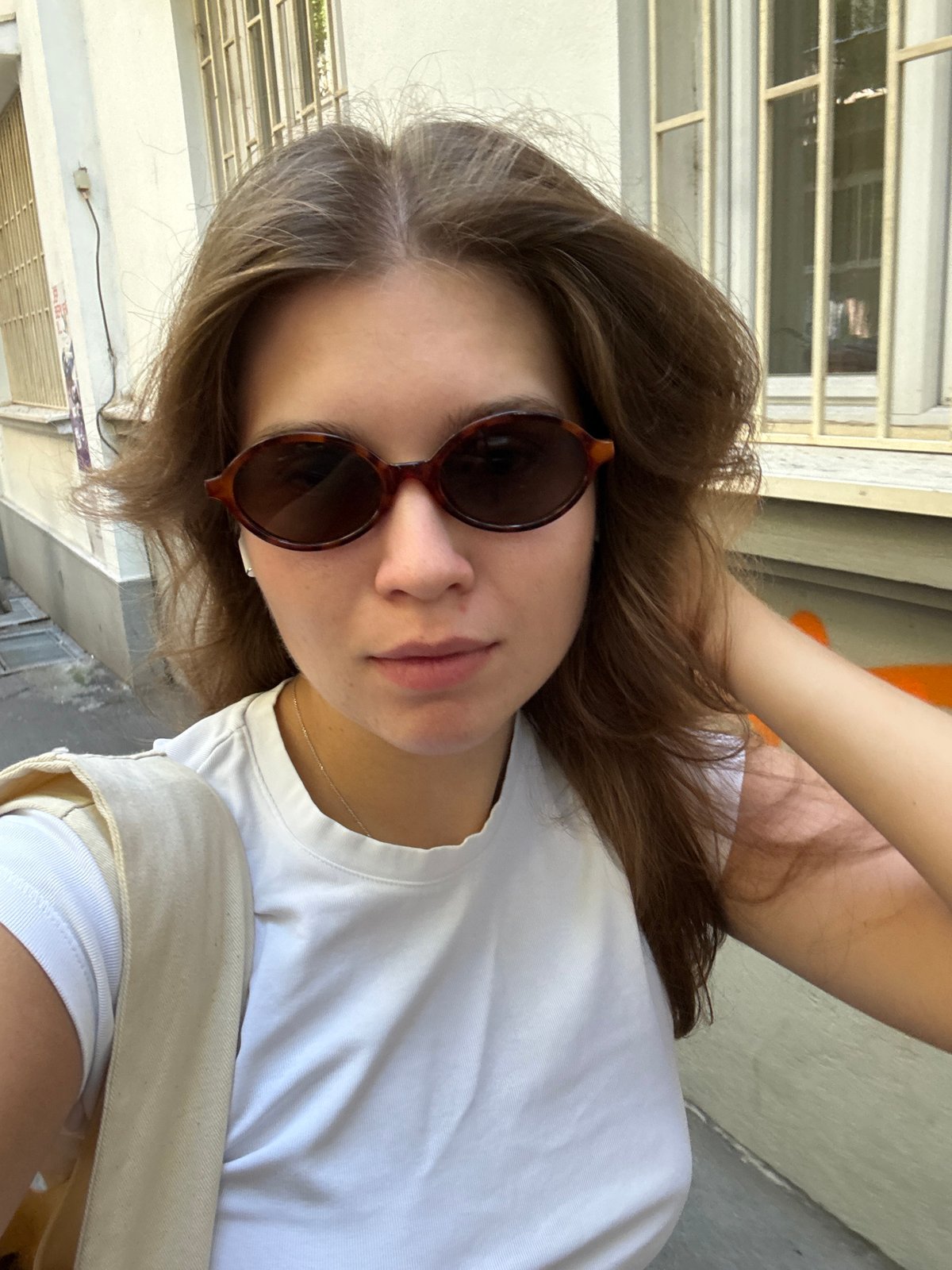 Woman takes selfie in graffitied Belgrade alleyway