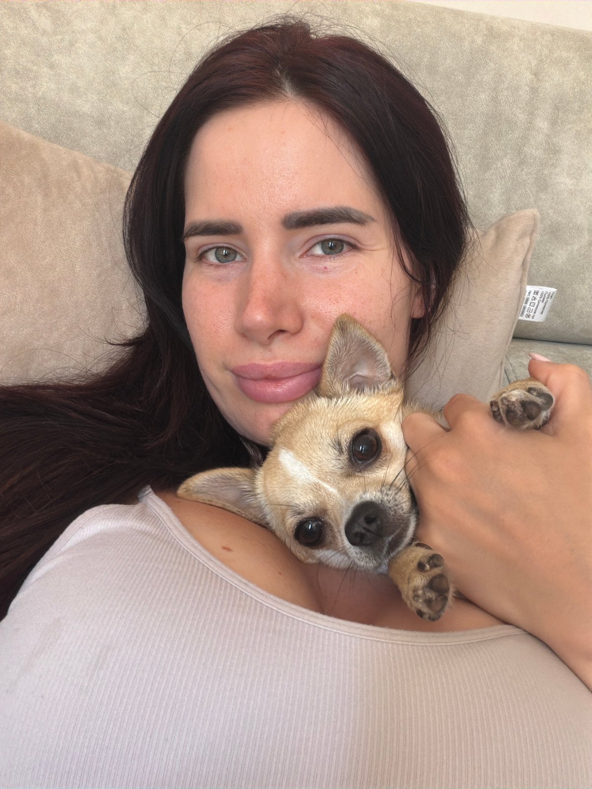 Woman and small dog share quiet afternoon moments in Sofia home